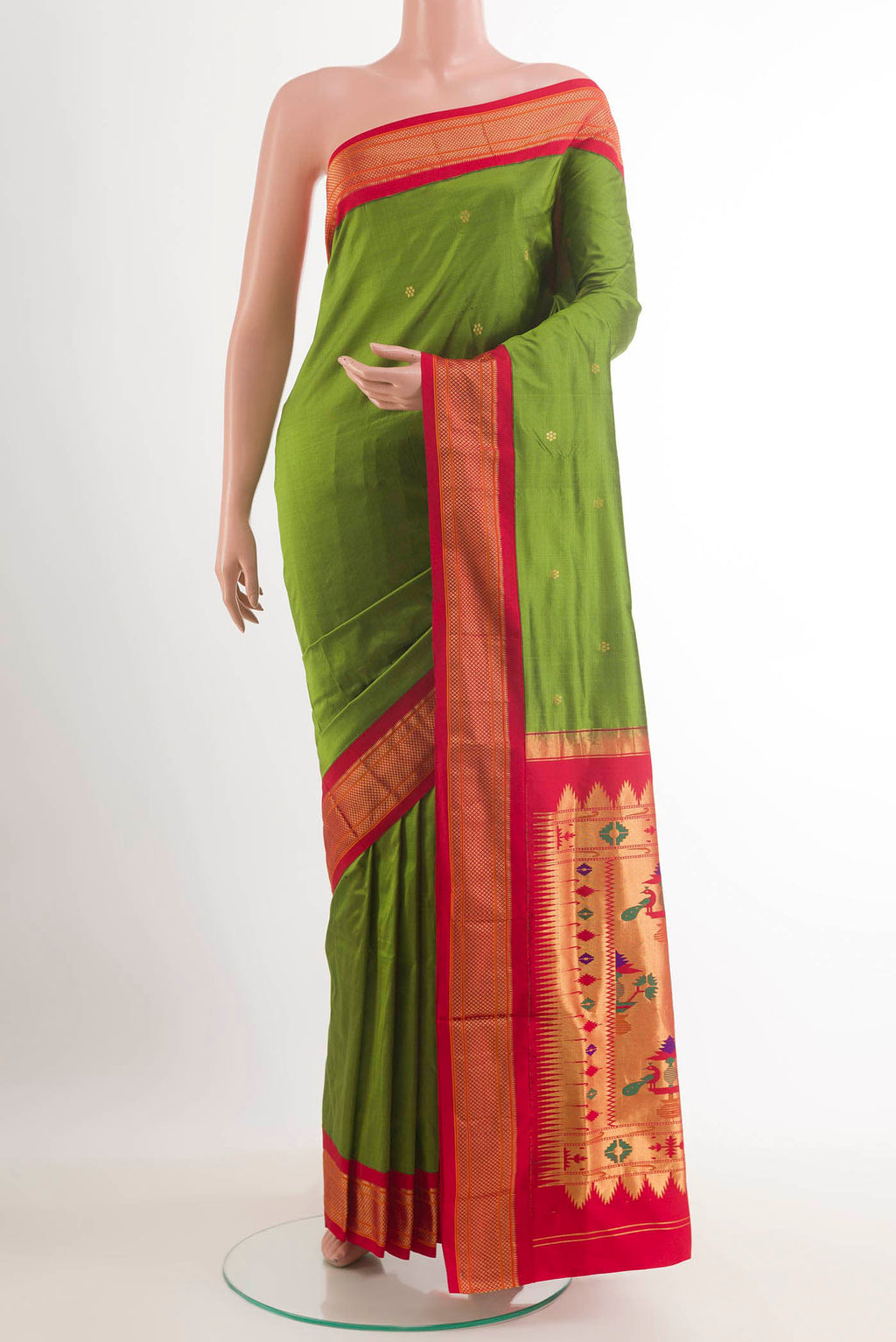 Green Soft Silk Saree with Zari Butta on the body and Zari Border.  displayed on a mannequin