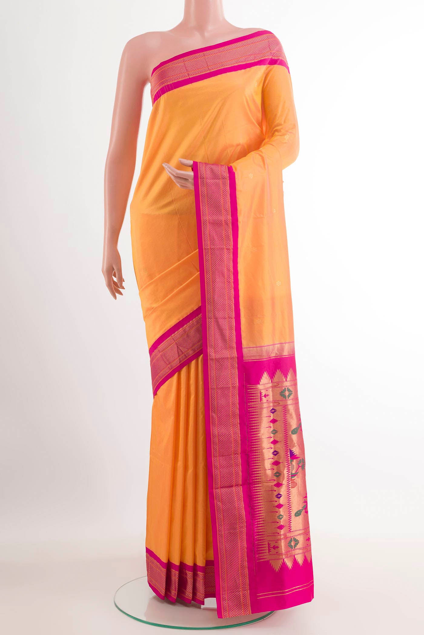 Orange Soft Silk Saree with Zari Butta on the body and Zari Border.  displayed on a mannequin