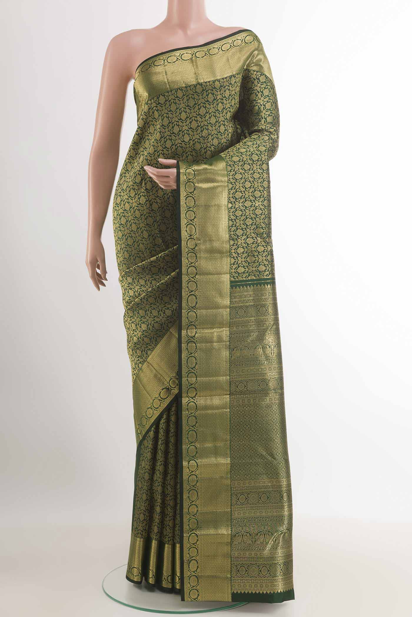 Bottle Green Kanchipuram Silk Saree with Zari Brocade on the body and Zari Border.  displayed on a mannequin