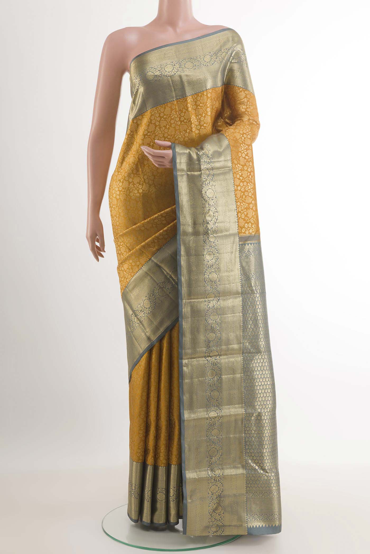 Yellow Kanchipuram Silk Saree with Zari Brocade on the body and Zari Border.  displayed on a mannequin