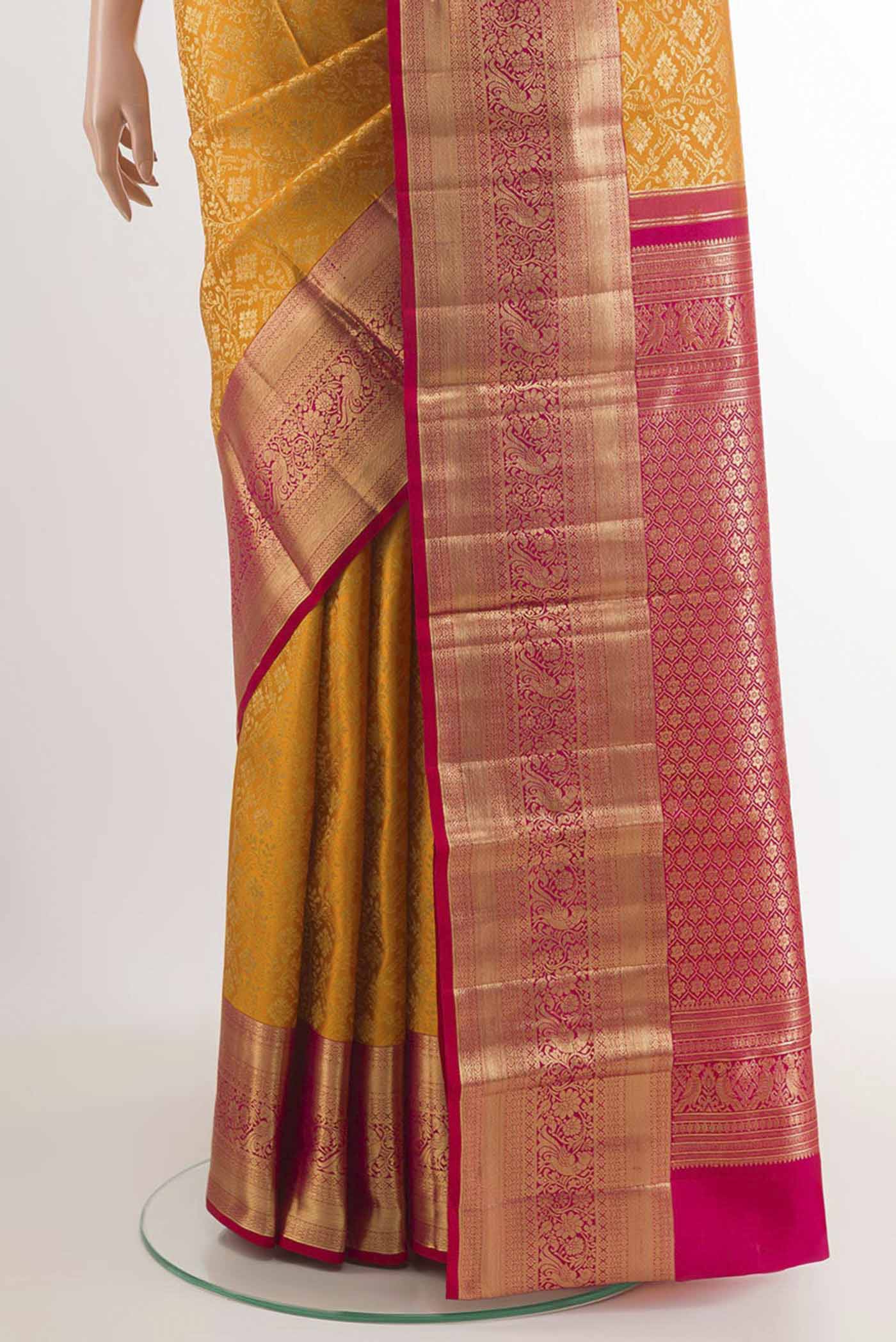 Pleats and pallu of Yellow Kanchipuram Silk Saree with Zari Brocade on the body and Zari Border. 