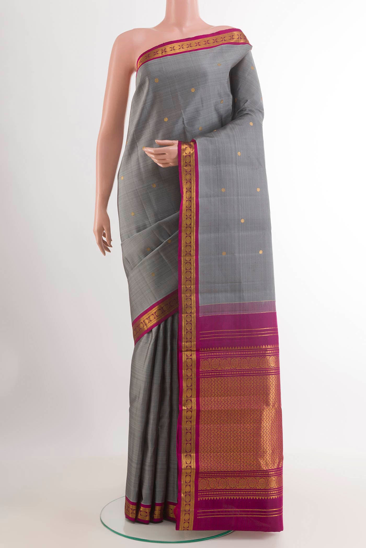 Grey Kanchipuram Silk Saree with Zari Butta on the body and Zari Border.  displayed on a mannequin