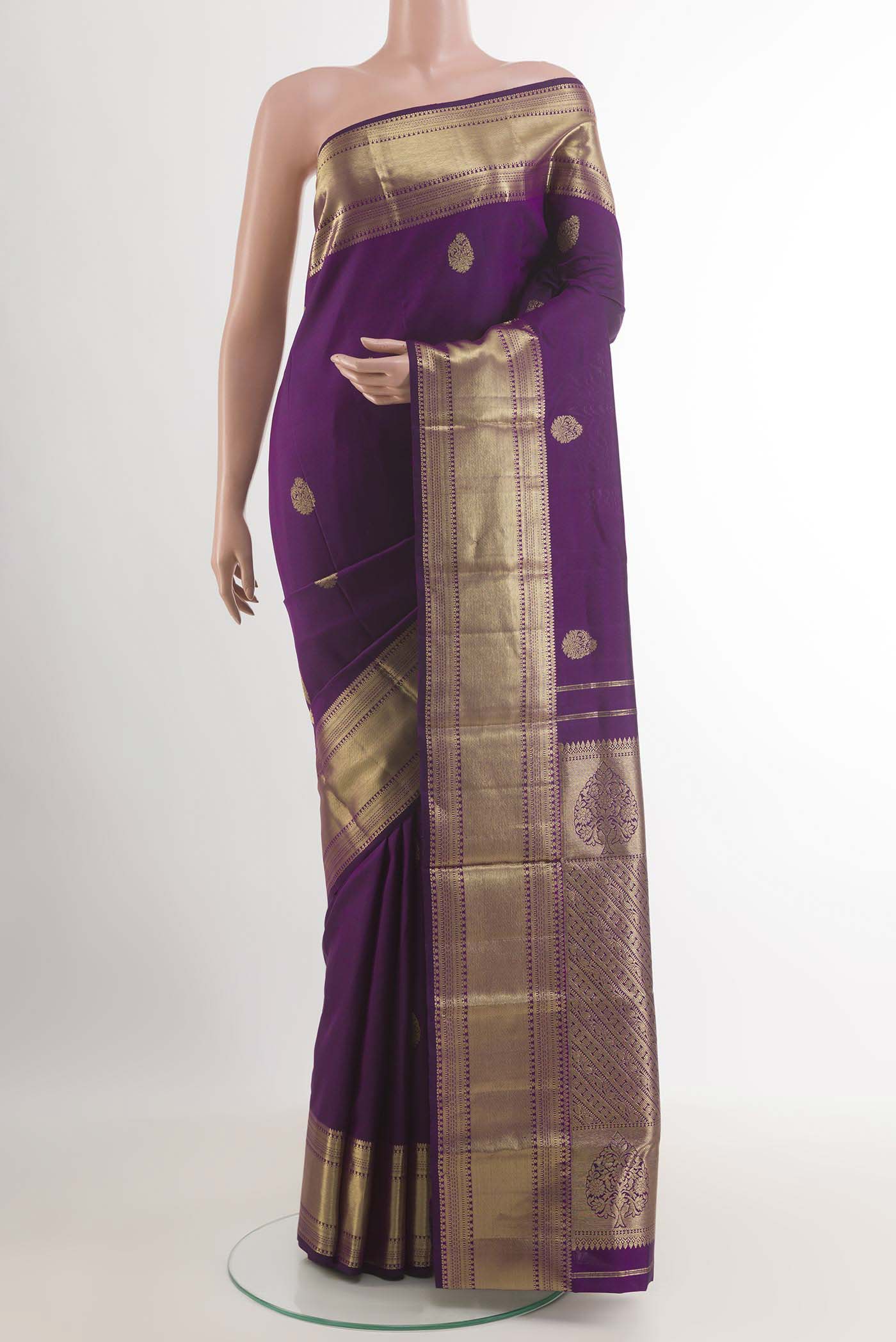 Purple Kanchipuram Silk Saree with Zari Butta on the body and Zari Border.  displayed on a mannequin