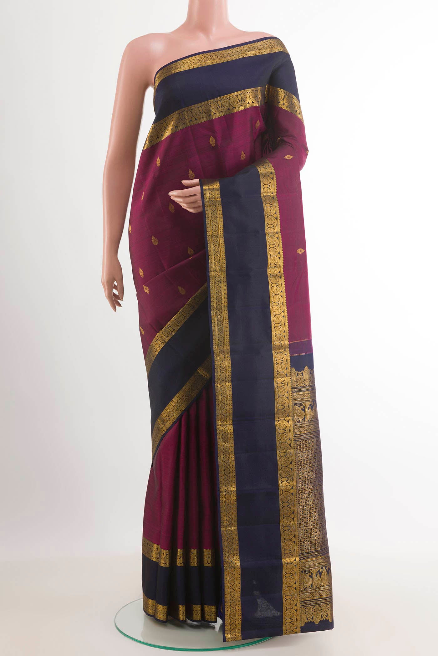 Purple Kanchipuram Silk Saree with Zari Butta on the body and Zari Border.  displayed on a mannequin