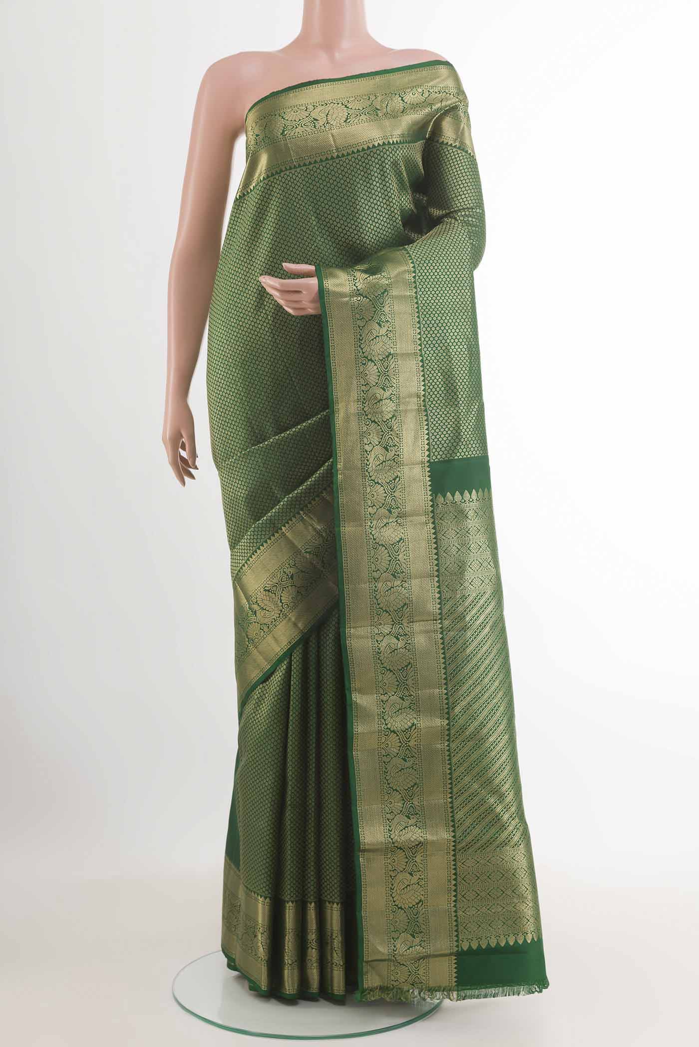 Green Kanjivaram Silk Saree with Zari Brocade on the body and Zari Border.  displayed on a mannequin