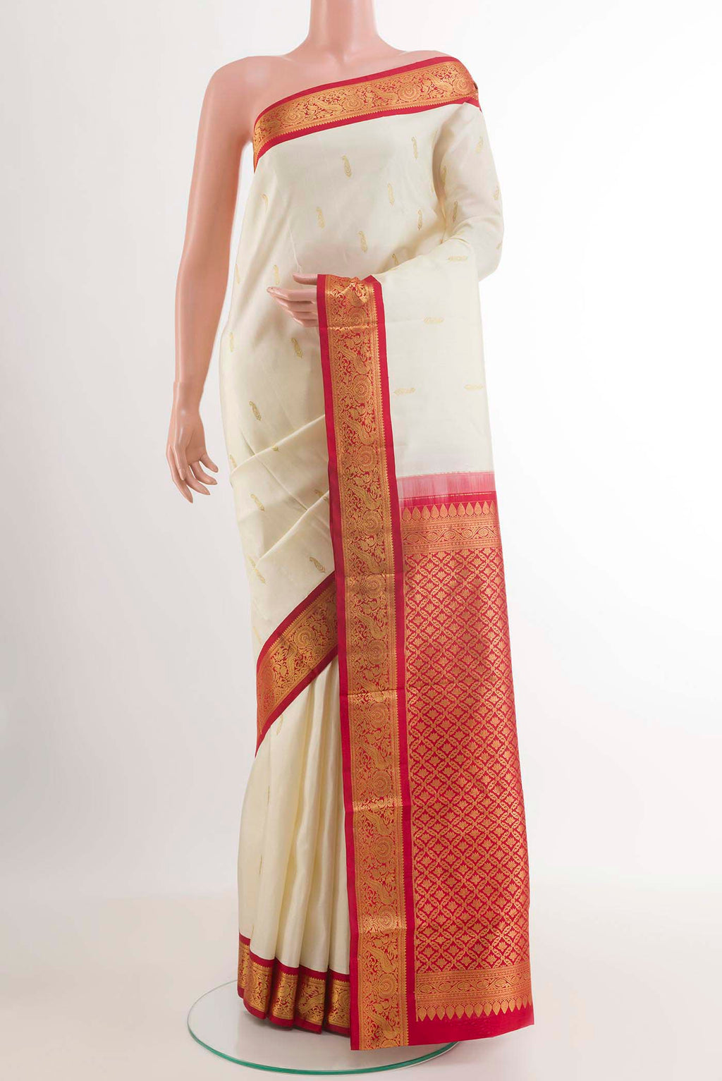 Off White Kanjivaram Silk Saree with Zari Butta on the body and Zari Border.  displayed on a mannequin