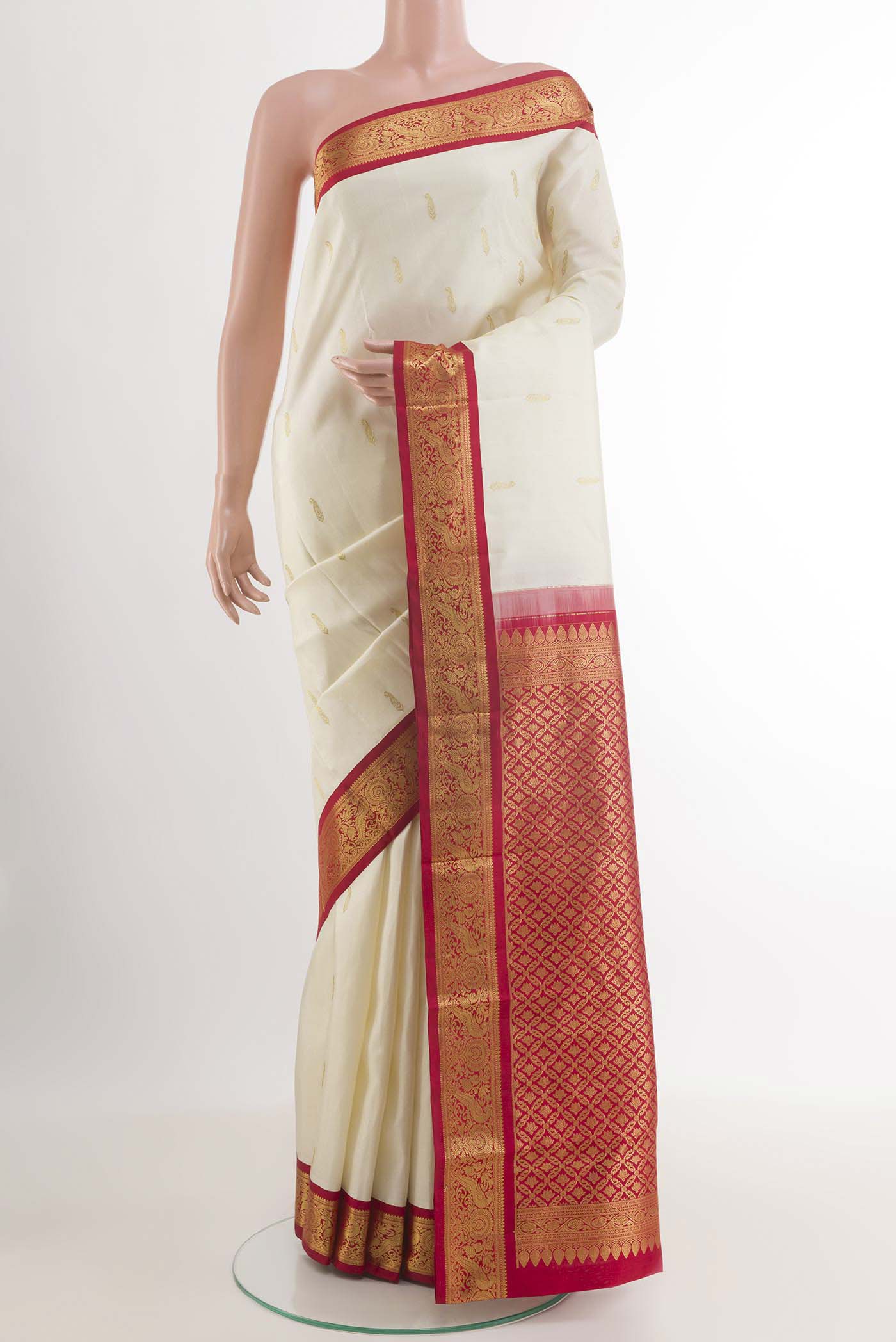 Off White Kanjivaram Silk Saree with Zari Butta on the body and Zari Border.  displayed on a mannequin
