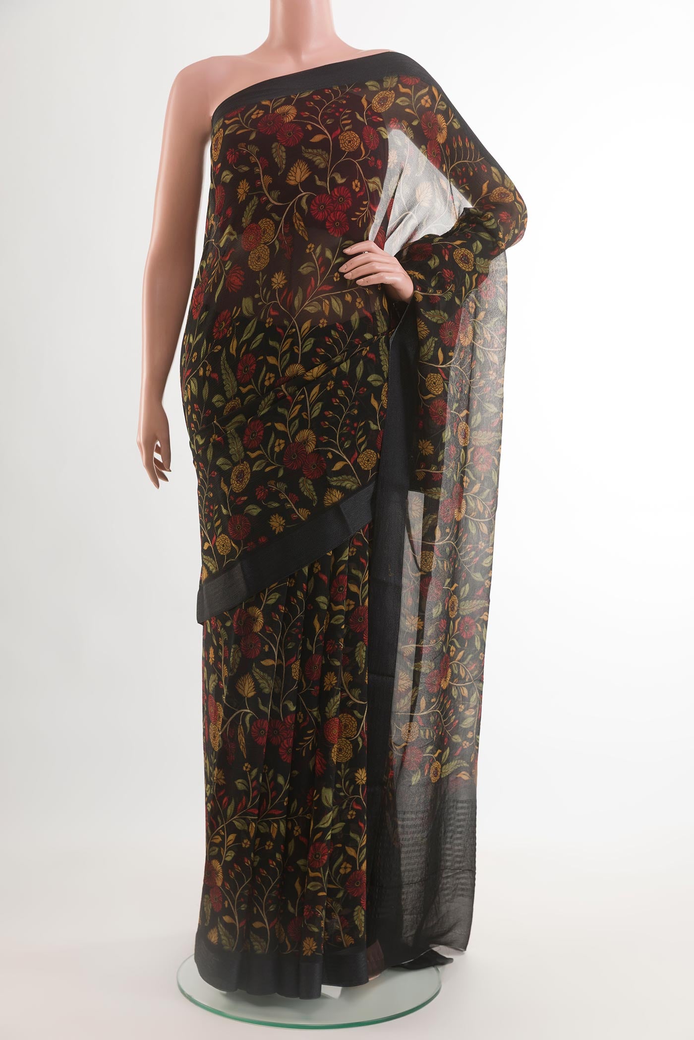 Black Chiffon Saree with Printed design on the body and Zari Border.  displayed on a mannequin