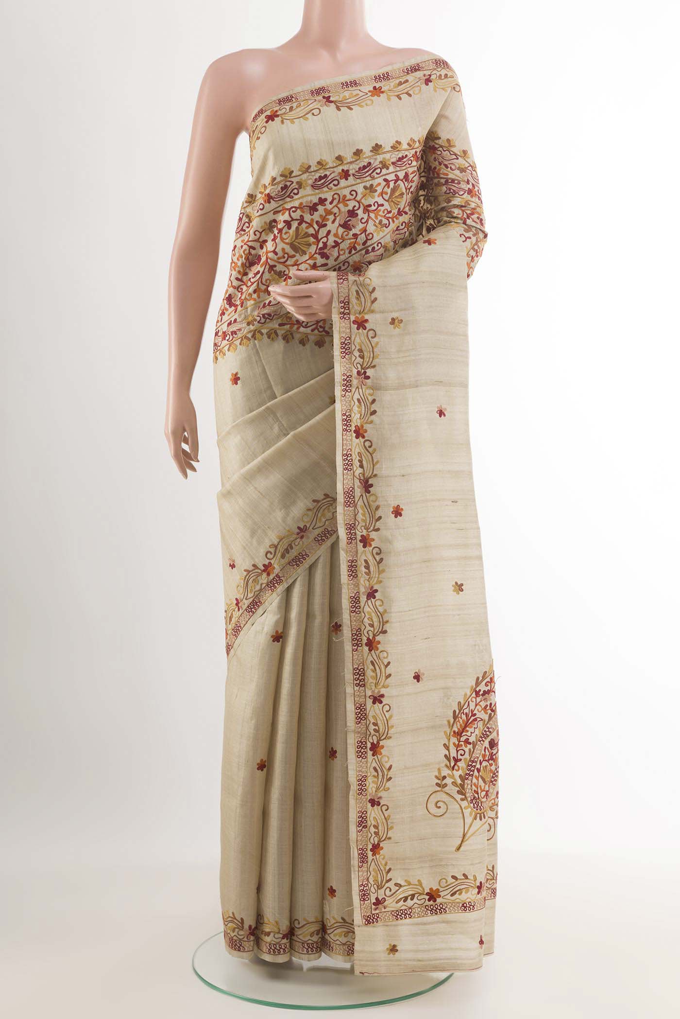 Off White Tussar Saree with Embroidery on the body and Embroidery Border.  displayed on a mannequin