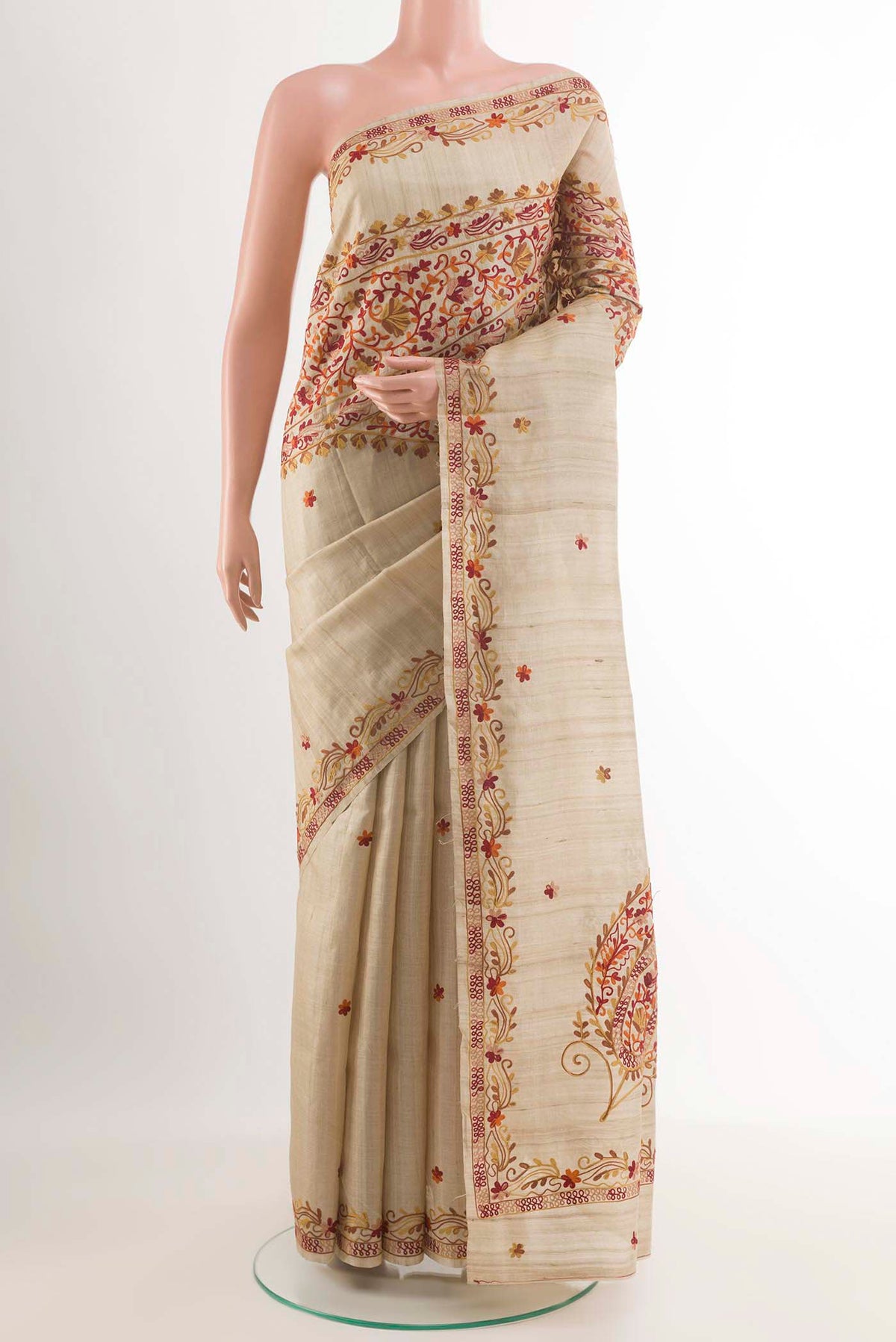 Off White Tussar Saree with Embroidery on the body and Embroidery Border.  displayed on a mannequin