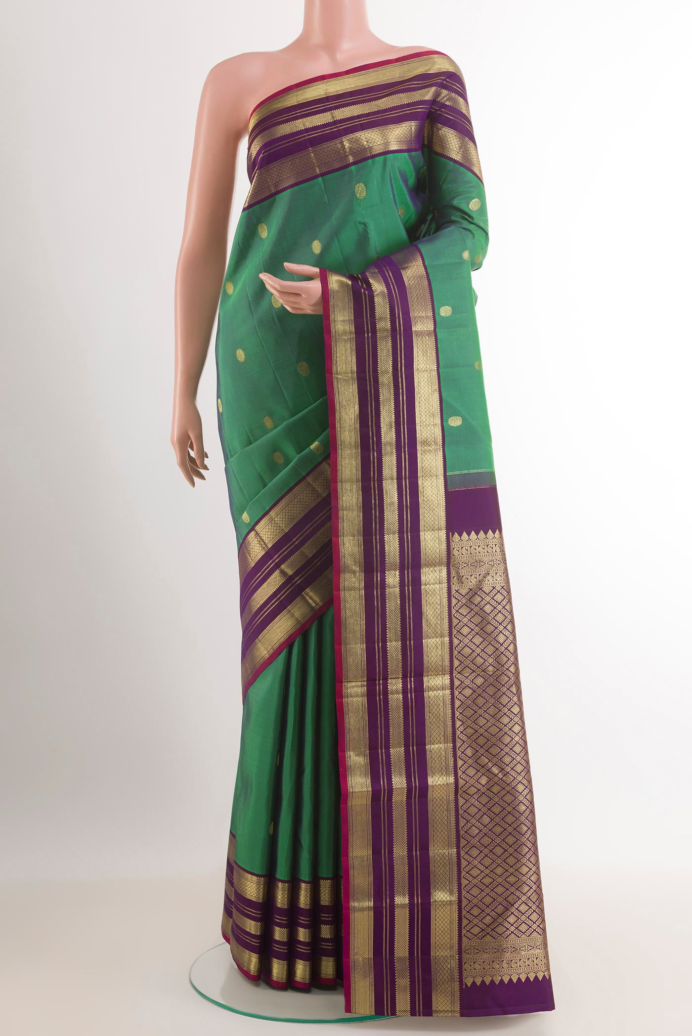 Green Kanchipuram Silk Saree with Zari Brocade on the body and Zari Border.  displayed on a mannequin