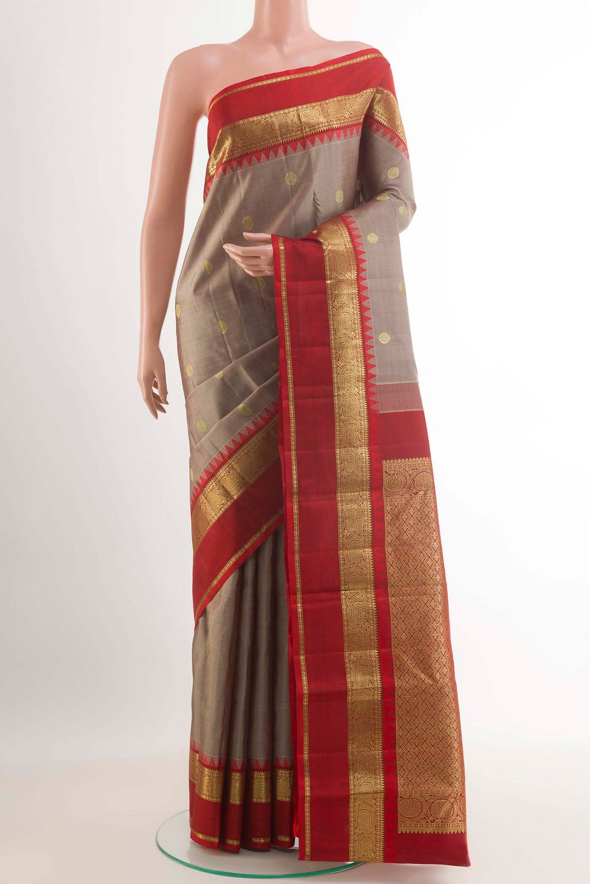 Grey Kanchipuram Silk Saree with Zari Butta on the body and Zari Border.  displayed on a mannequin