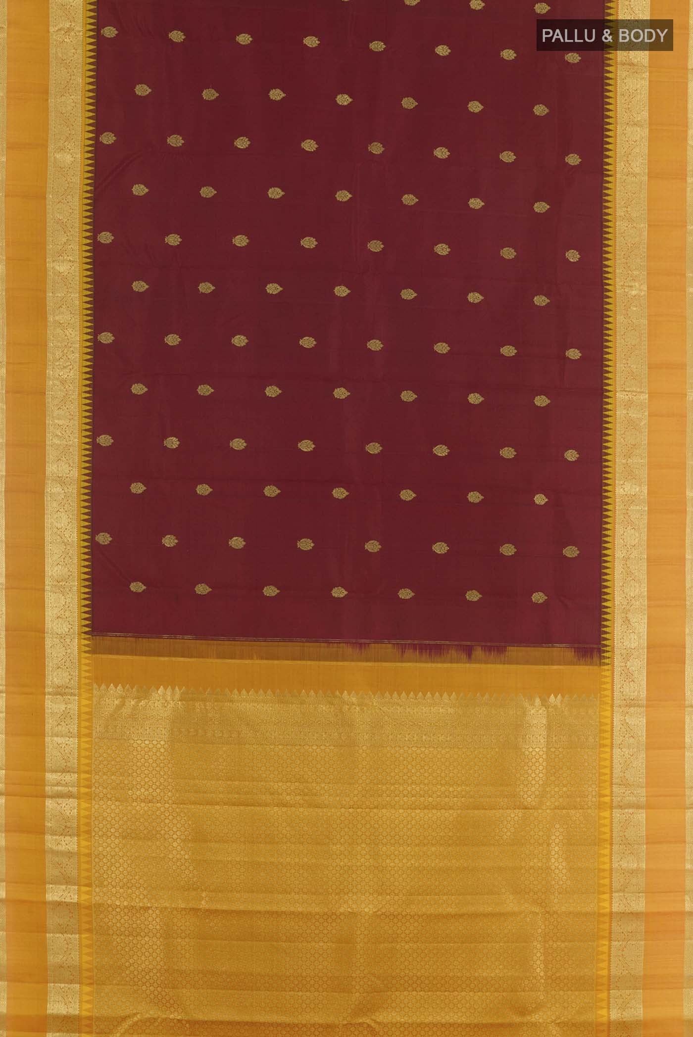 Flat view of Maroon Kanchipuram Silk Saree with Zari Butta on the body and Zari Border. 