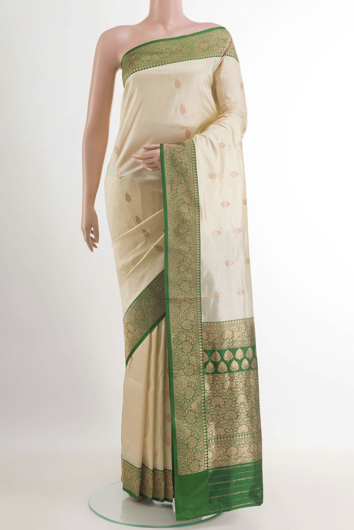 Cream Banarasi Silk Saree with Zari Butta on the body and Zari Border.  displayed on a mannequin