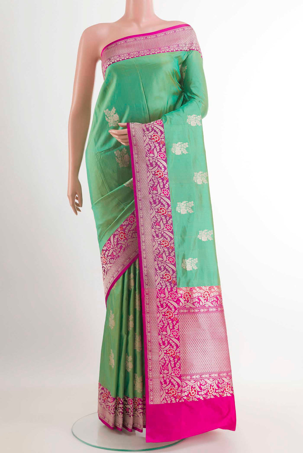 Green Banarasi Silk Saree with Zari Butta on the body and Zari Border.  displayed on a mannequin
