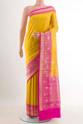Yellow Banarasi Katan Silk Saree with Zari Butta on the body and Zari Border.  displayed on a mannequin