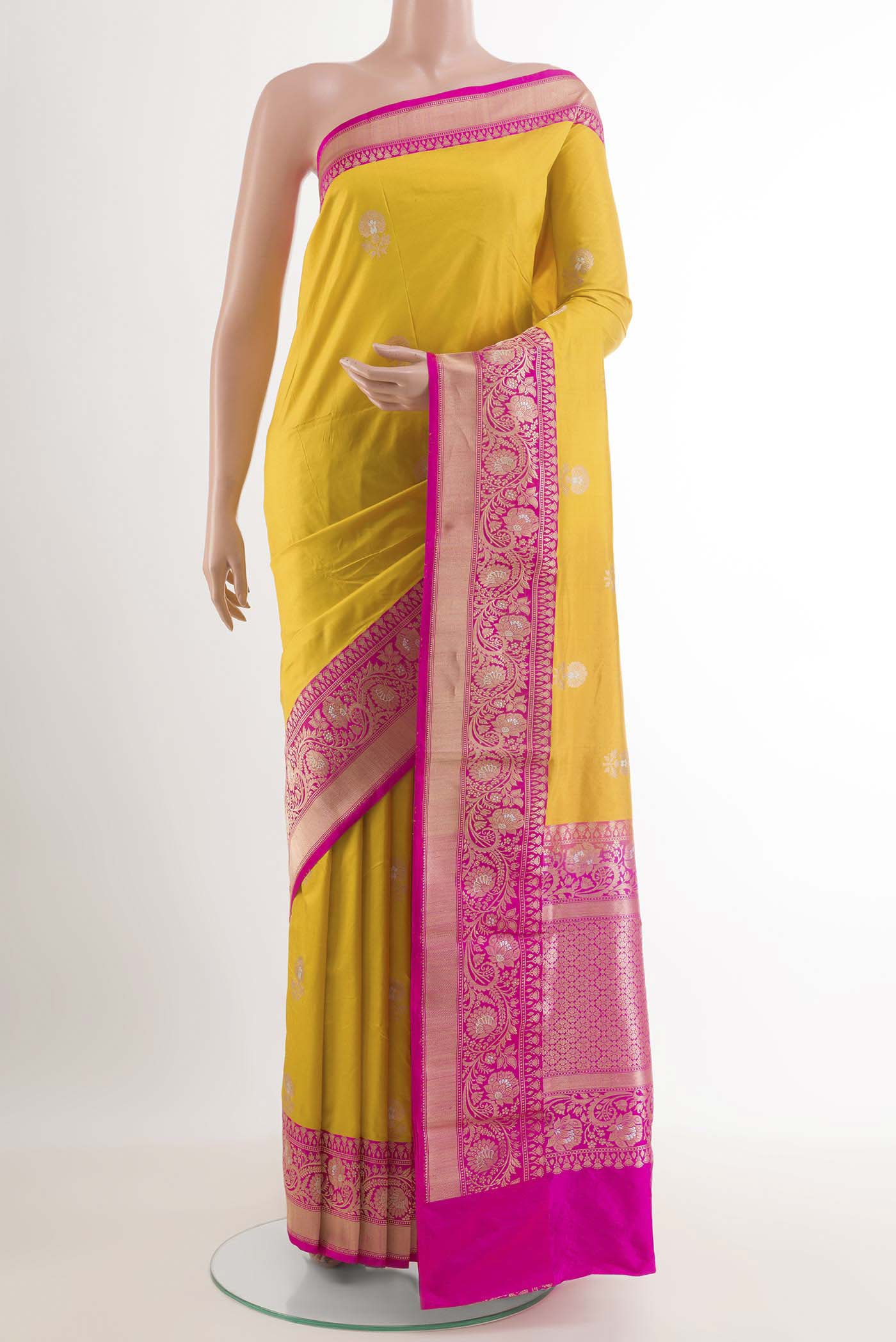 Yellow Banarasi Katan Silk Saree with Zari Butta on the body and Zari Border.  displayed on a mannequin