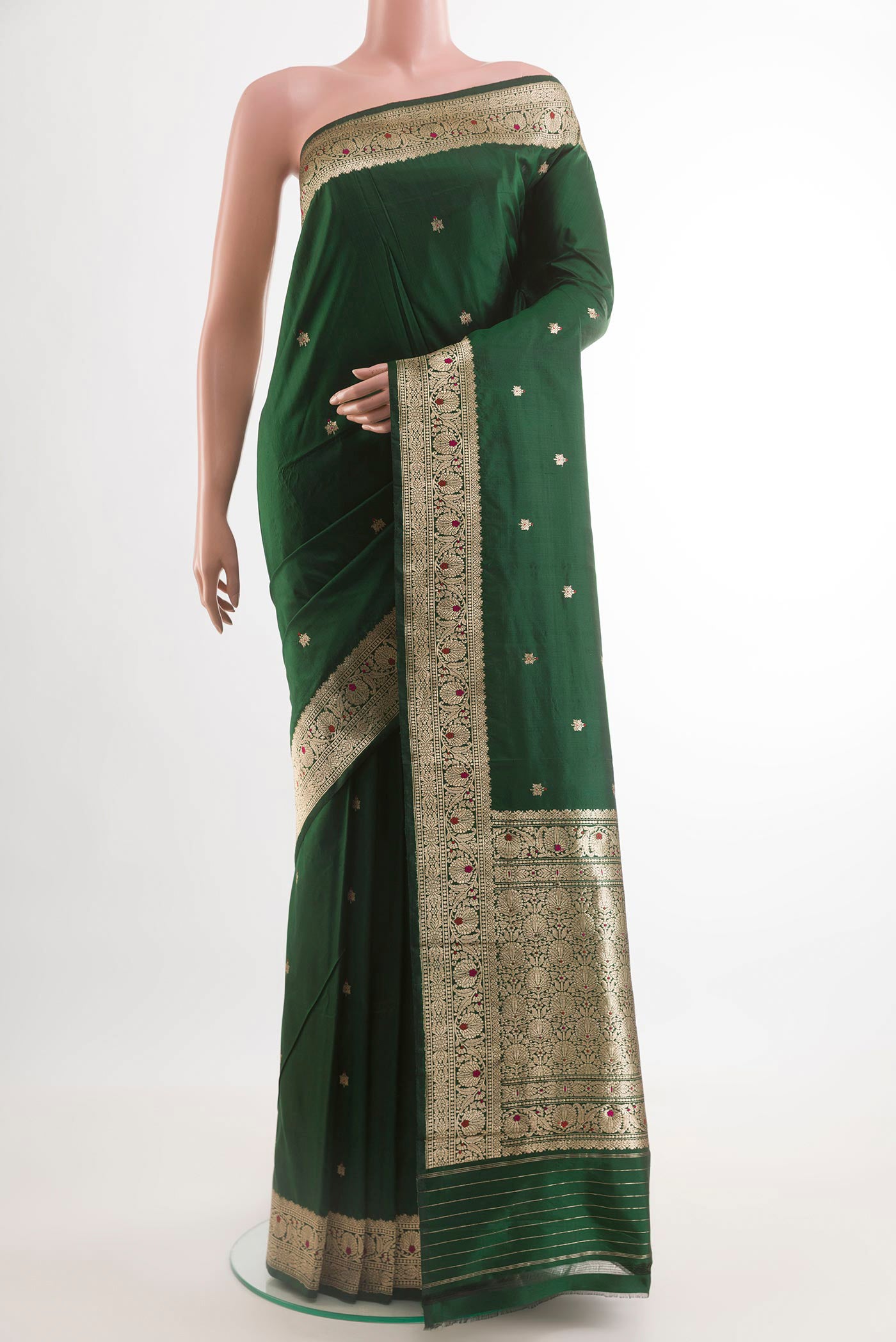 Bottle Green Banarasi Katan Silk Saree with Zari Butta on the body and Zari Border.  displayed on a mannequin