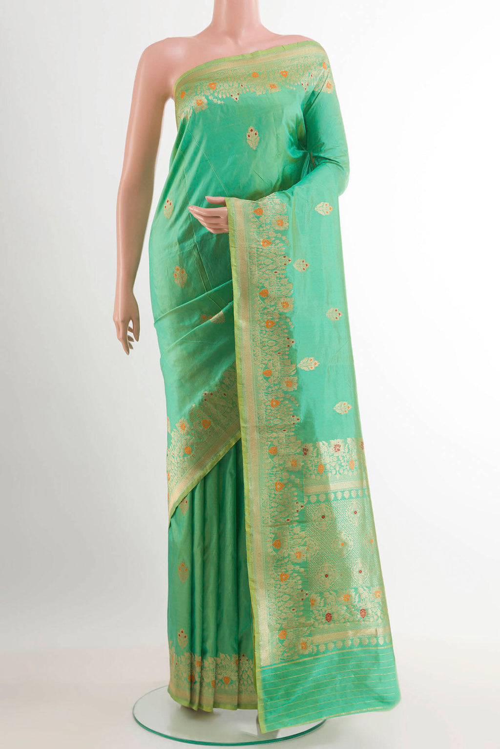 Green Banarasi Katan Silk Saree with Zari Butta on the body and Zari Border.  displayed on a mannequin