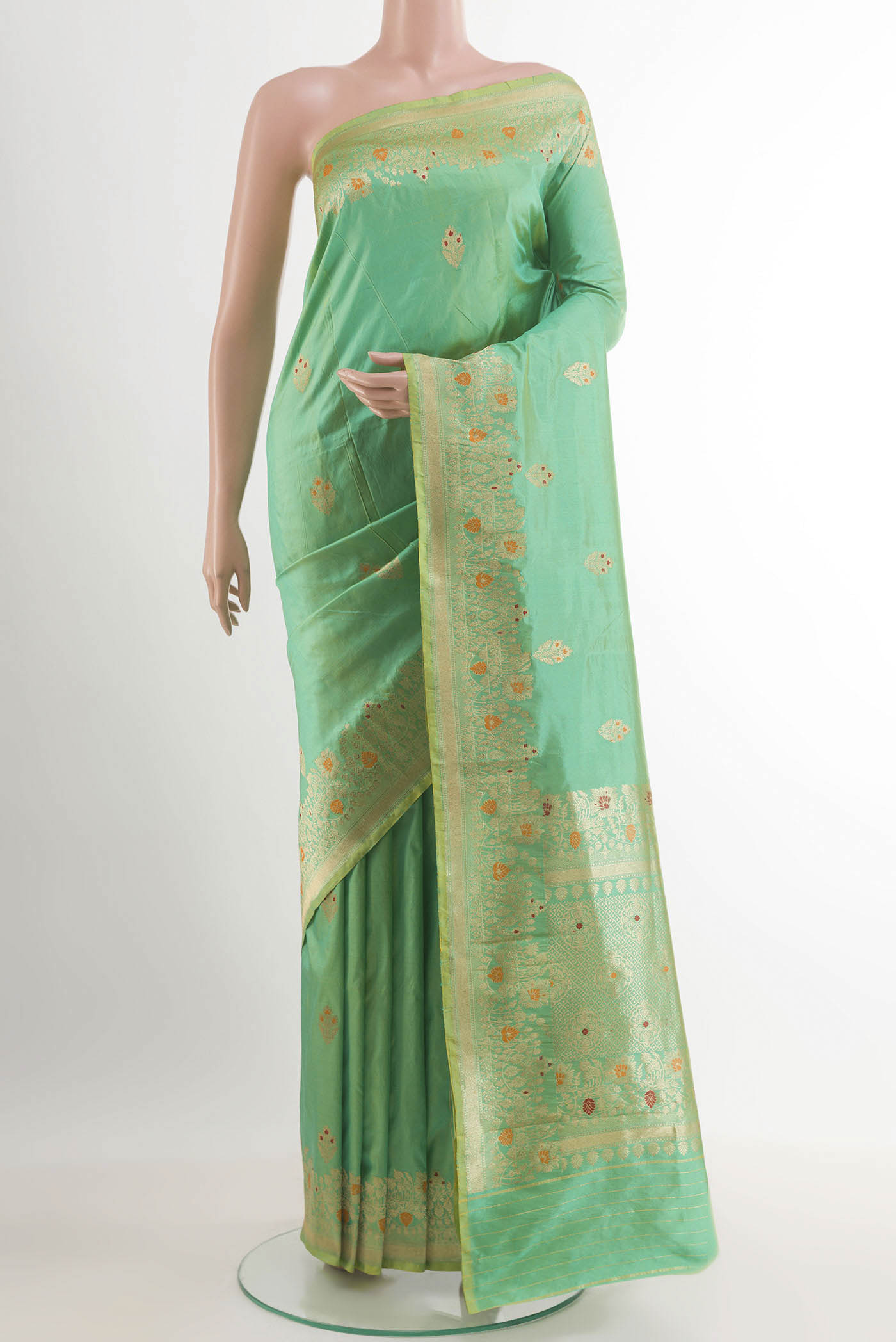 Green Banarasi Katan Silk Saree with Zari Butta on the body and Zari Border.  displayed on a mannequin