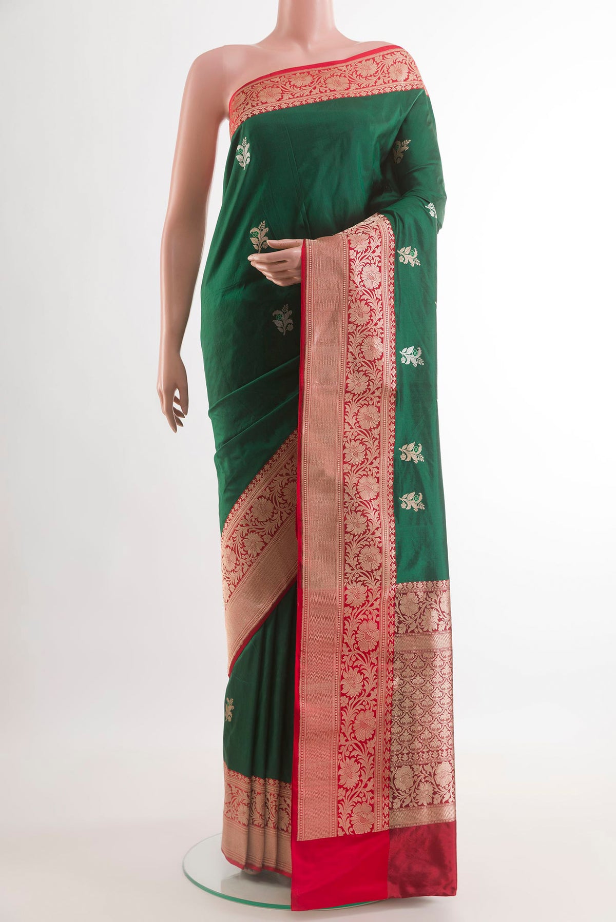 Bottle Green Banarasi Katan Silk Saree with Zari Butta on the body and Zari Border.  displayed on a mannequin