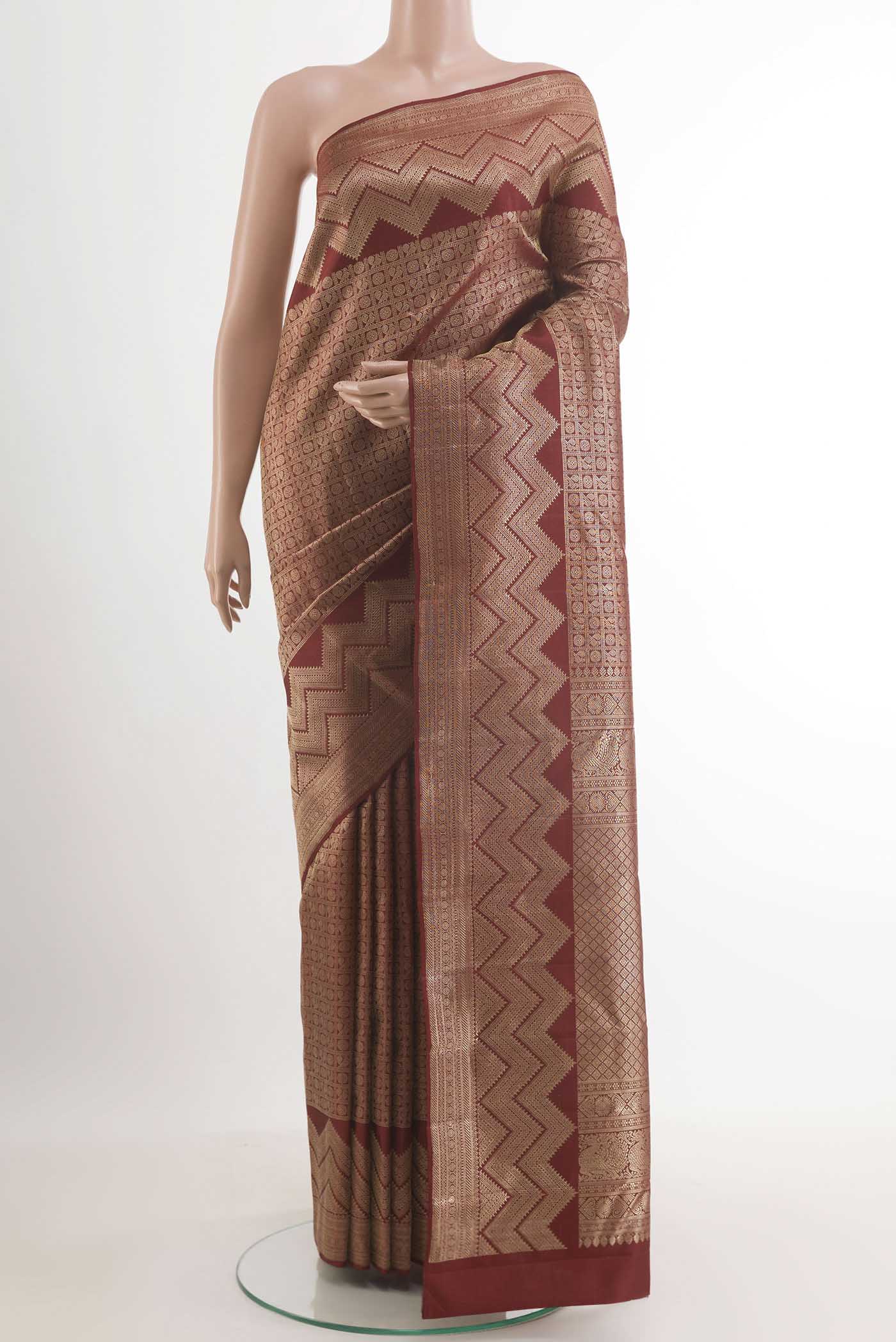 Maroon Kanchipuram Silk Saree with Zari Brocade on the body and Zari Border.  displayed on a mannequin