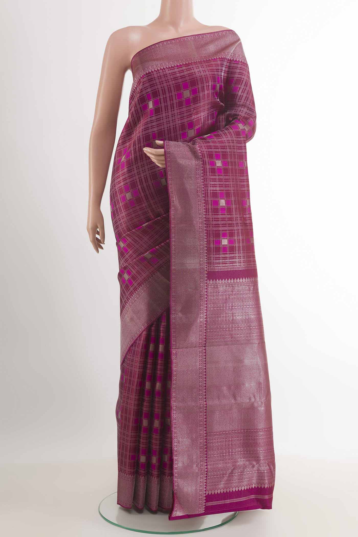 Purple Kanjivaram Silk Saree with Zari Brocade on the body and Ganga Jamuna Border.  displayed on a mannequin