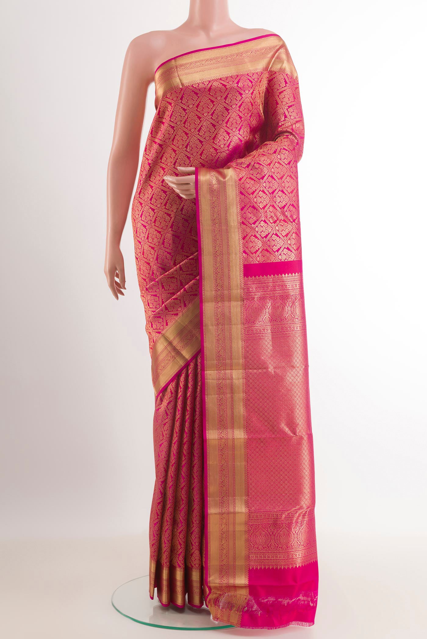 Rani Pink Kanchipuram Silk Saree with Zari Brocade on the body and Zari Border.  displayed on a mannequin