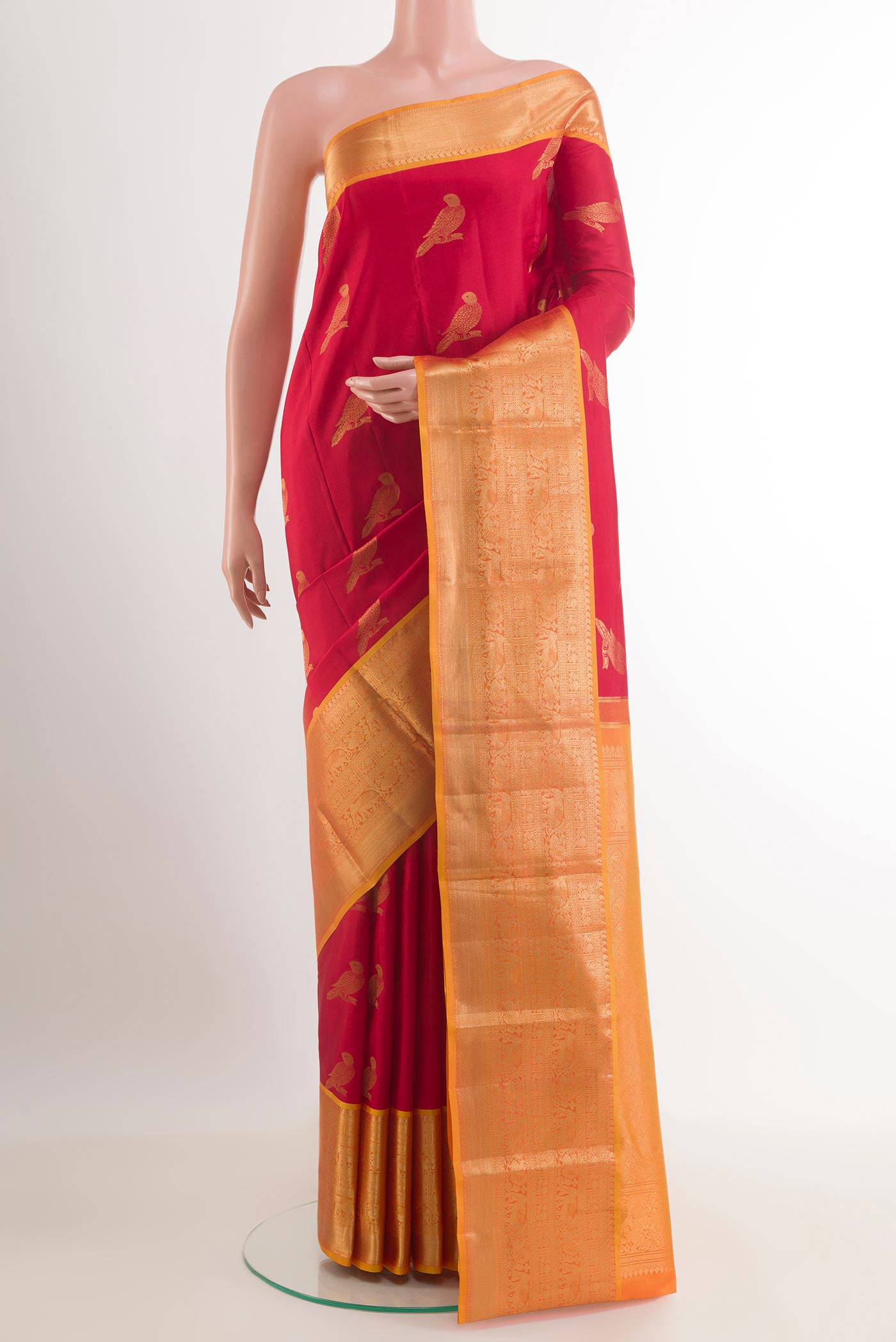 Red Kanchipuram Silk Saree with Zari Butta on the body and Zari Border.  displayed on a mannequin