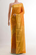 Mustard Kanchipuram Silk Saree with Zari Butta on the body and Zari Border.  displayed on a mannequin