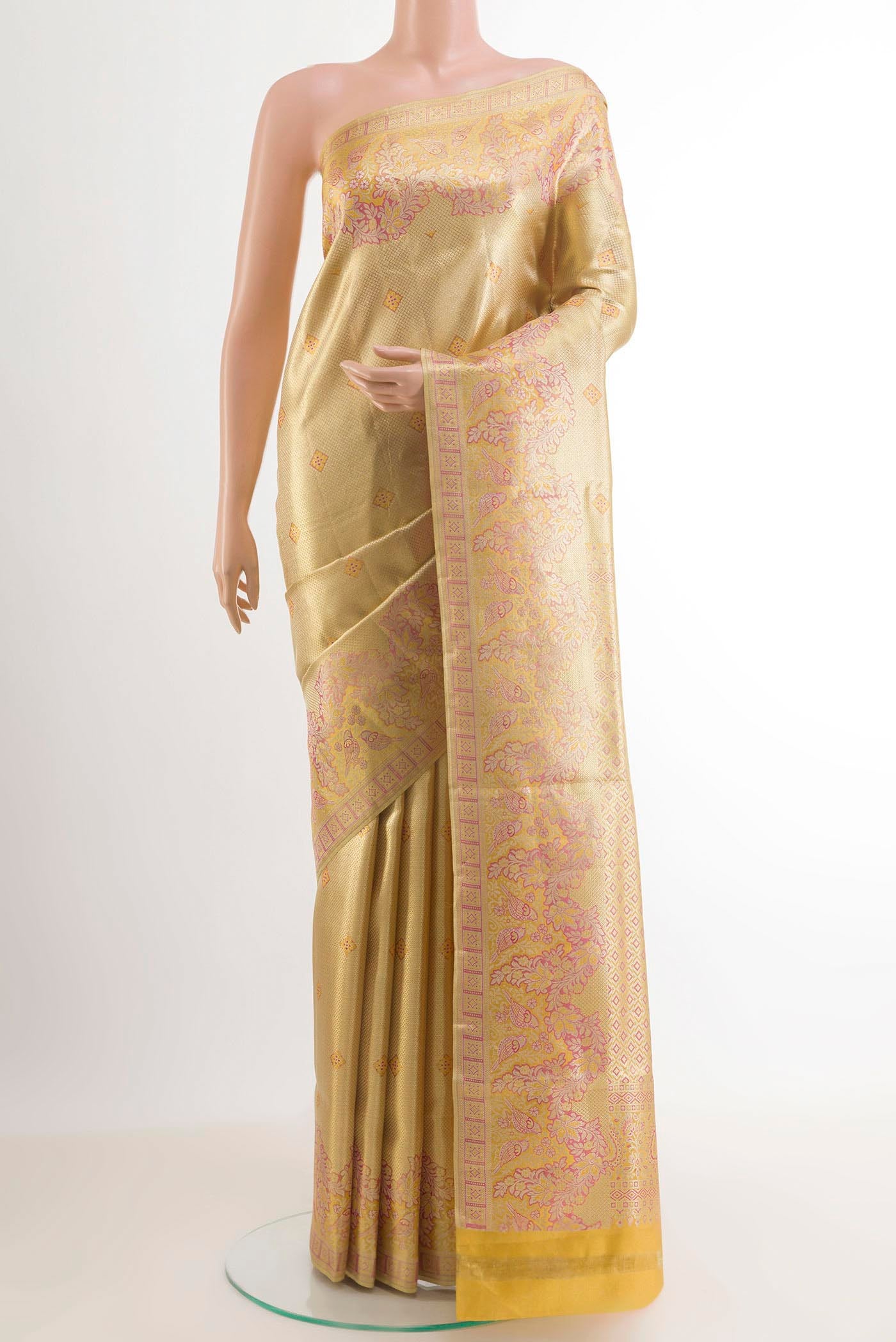 Golden Kanjivaram Tissue Silk Saree with Zari Brocade on the body and Zari Border.  displayed on a mannequin