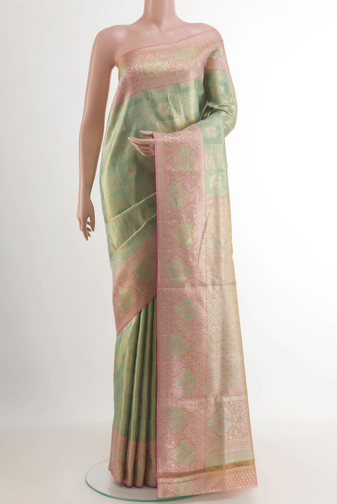 Green Kanjivaram Tissue Silk Saree with Zari Brocade on the body and Zari Border.  displayed on a mannequin
