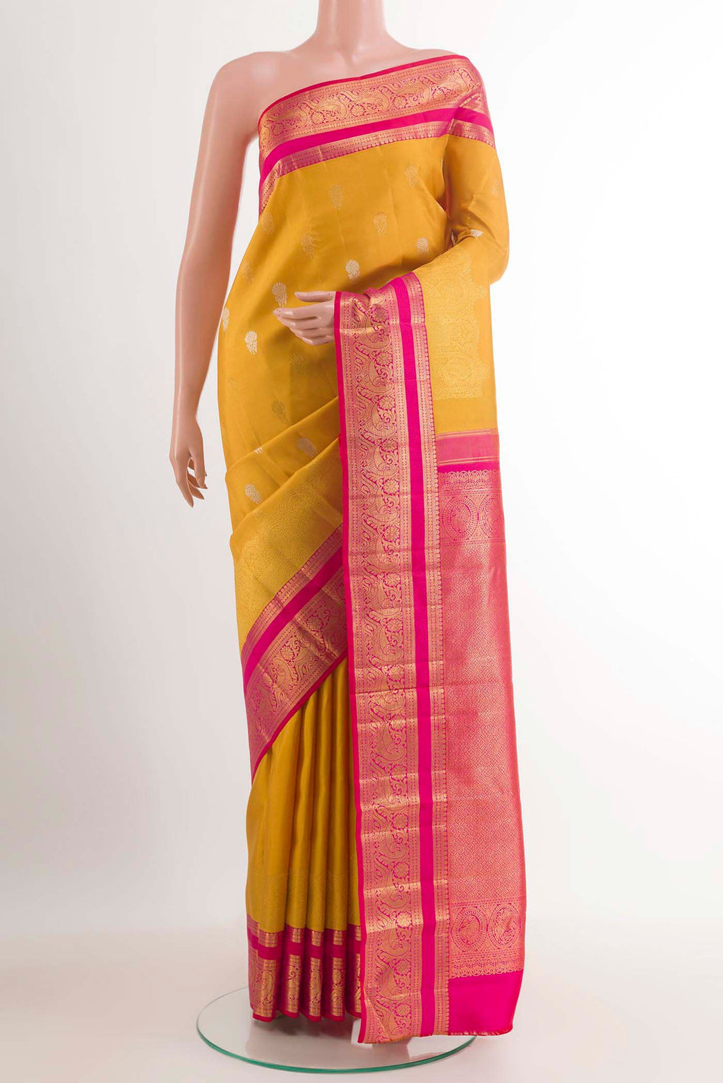 Yellow Kanchipuram Silk Saree with Zari Butta on the body and Ganga Jamuna Border.  displayed on a mannequin
