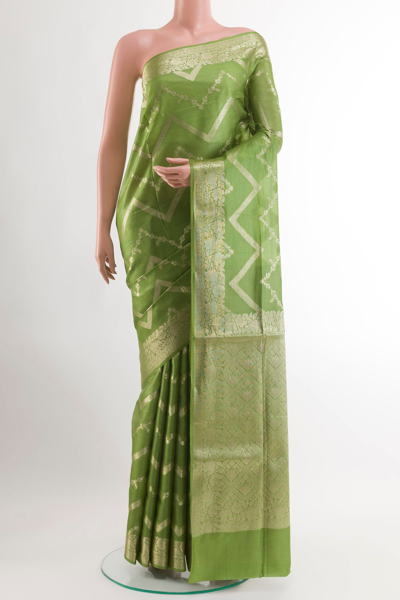 Green Tussar Silk Saree with Zari Brocade on the body and Zari Border.  displayed on a mannequin