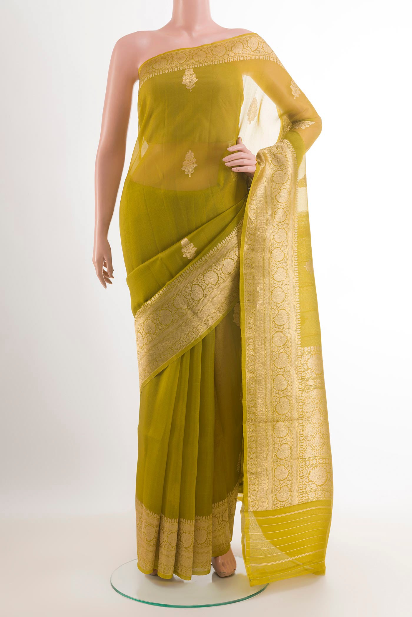 Green Banarasi Kora Silk Saree with Zari Butta on the body and Zari Border.  displayed on a mannequin