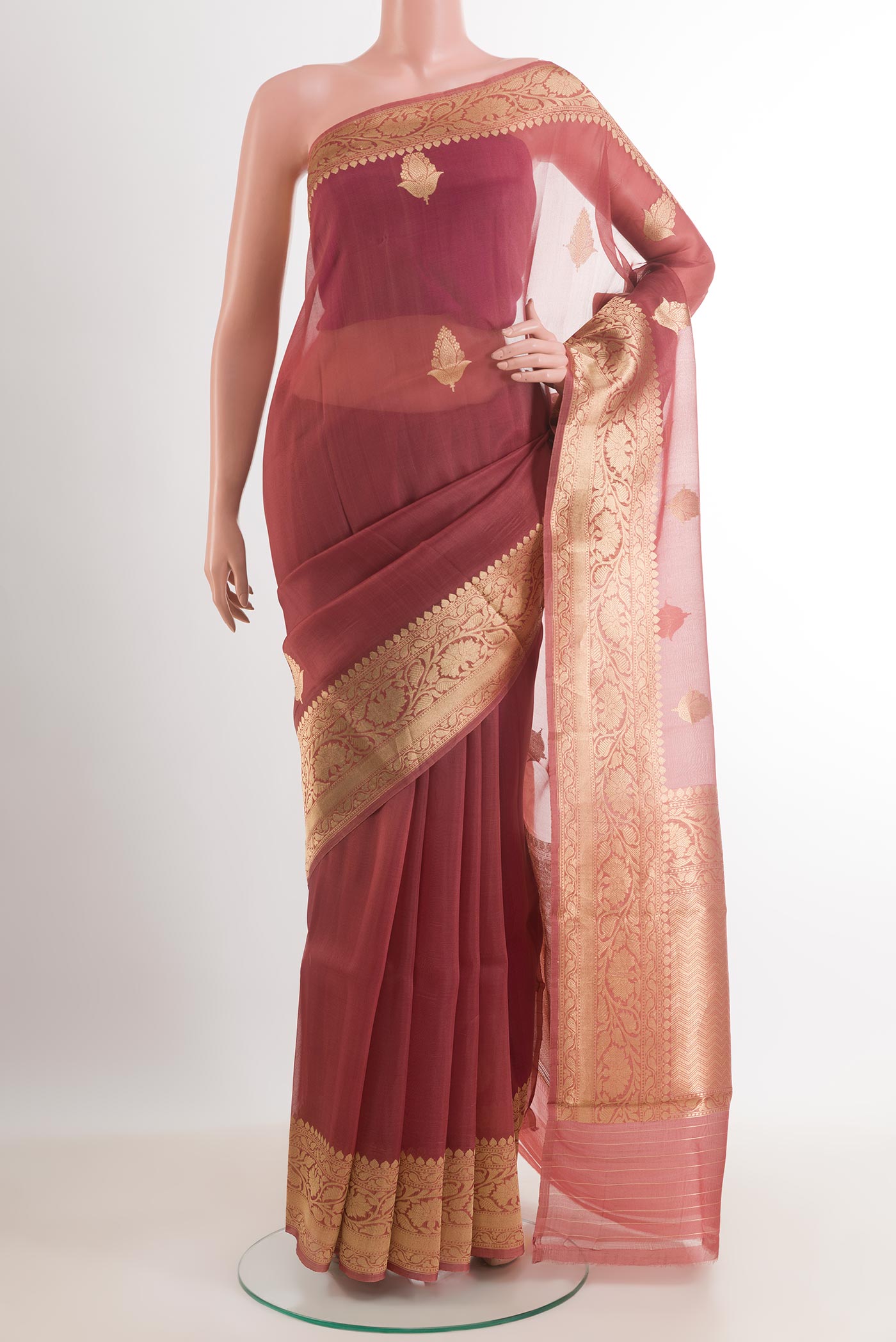 Peach Organza Silk Saree with Zari Butta on the body and Zari Border.  displayed on a mannequin