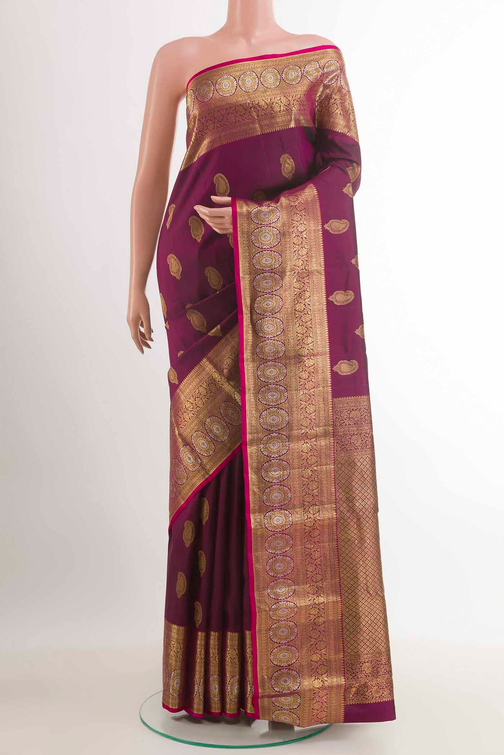 Purple Kanjivaram Silk Saree with Zari Butta on the body and Zari Border.  displayed on a mannequin