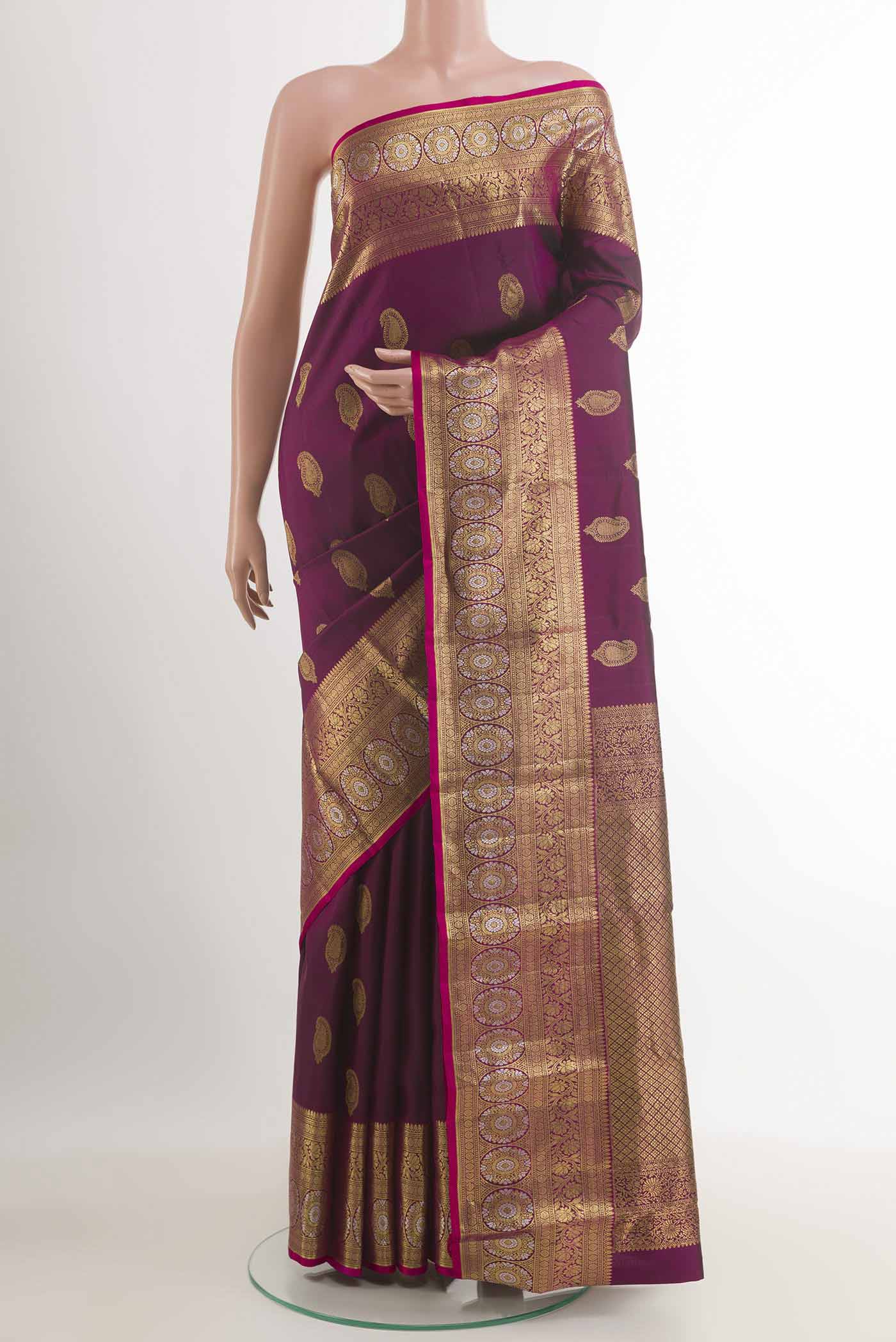 Purple Kanjivaram Silk Saree with Zari Butta on the body and Zari Border.  displayed on a mannequin