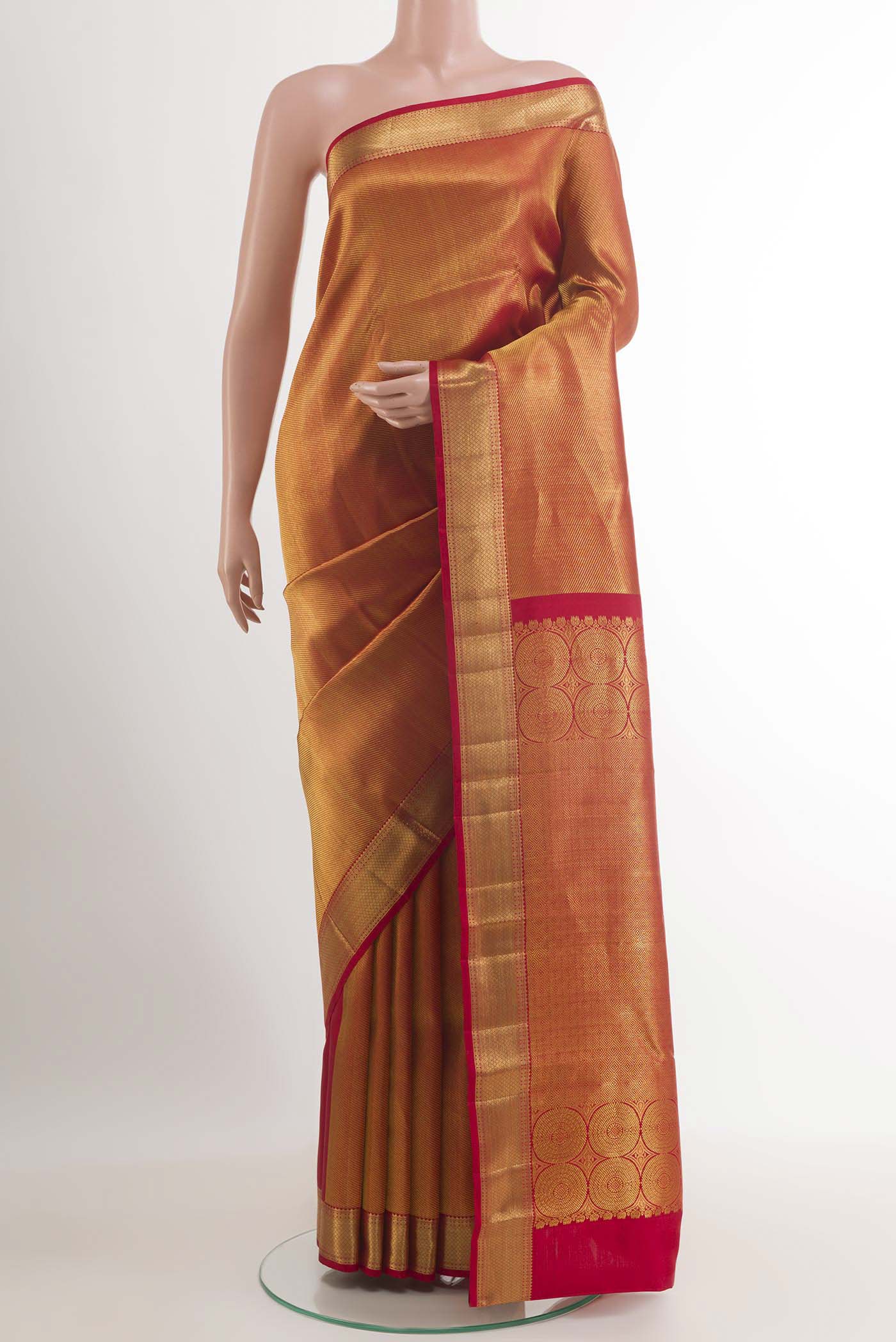 Golden Kanchipuram Silk Saree with Zari Brocade on the body and Ganga Jamuna Border.  displayed on a mannequin