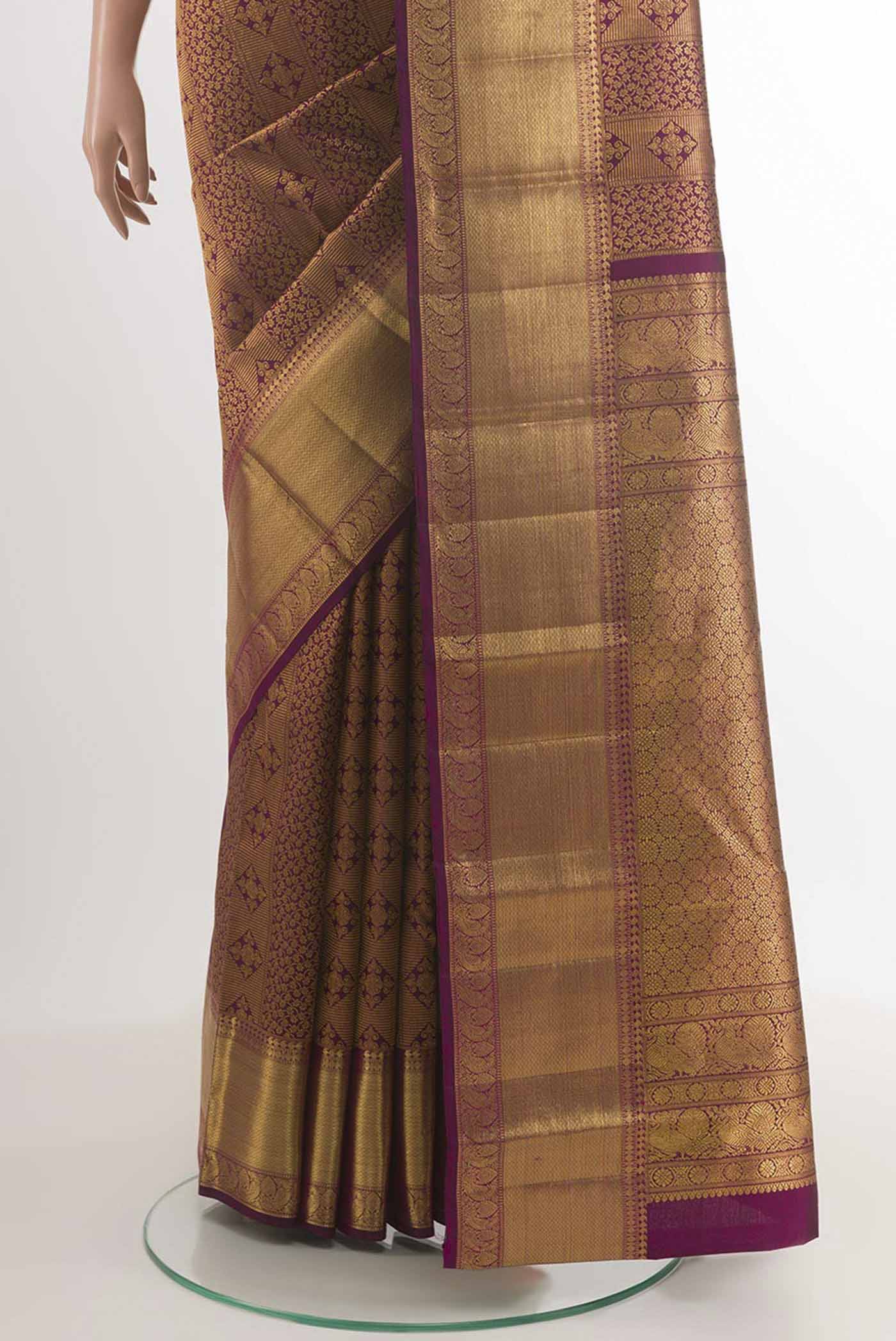Pleats and pallu of Purple Kanchipuram Silk Saree with Zari Brocade on the body and Zari Border. 