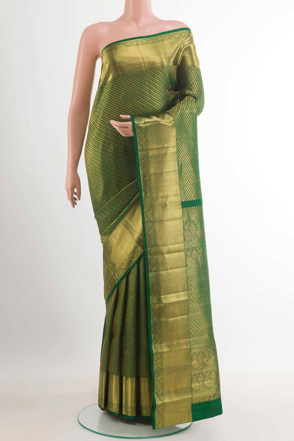 Green Kanchipuram Silk Saree with Zari Brocade on the body and Zari Border.  displayed on a mannequin