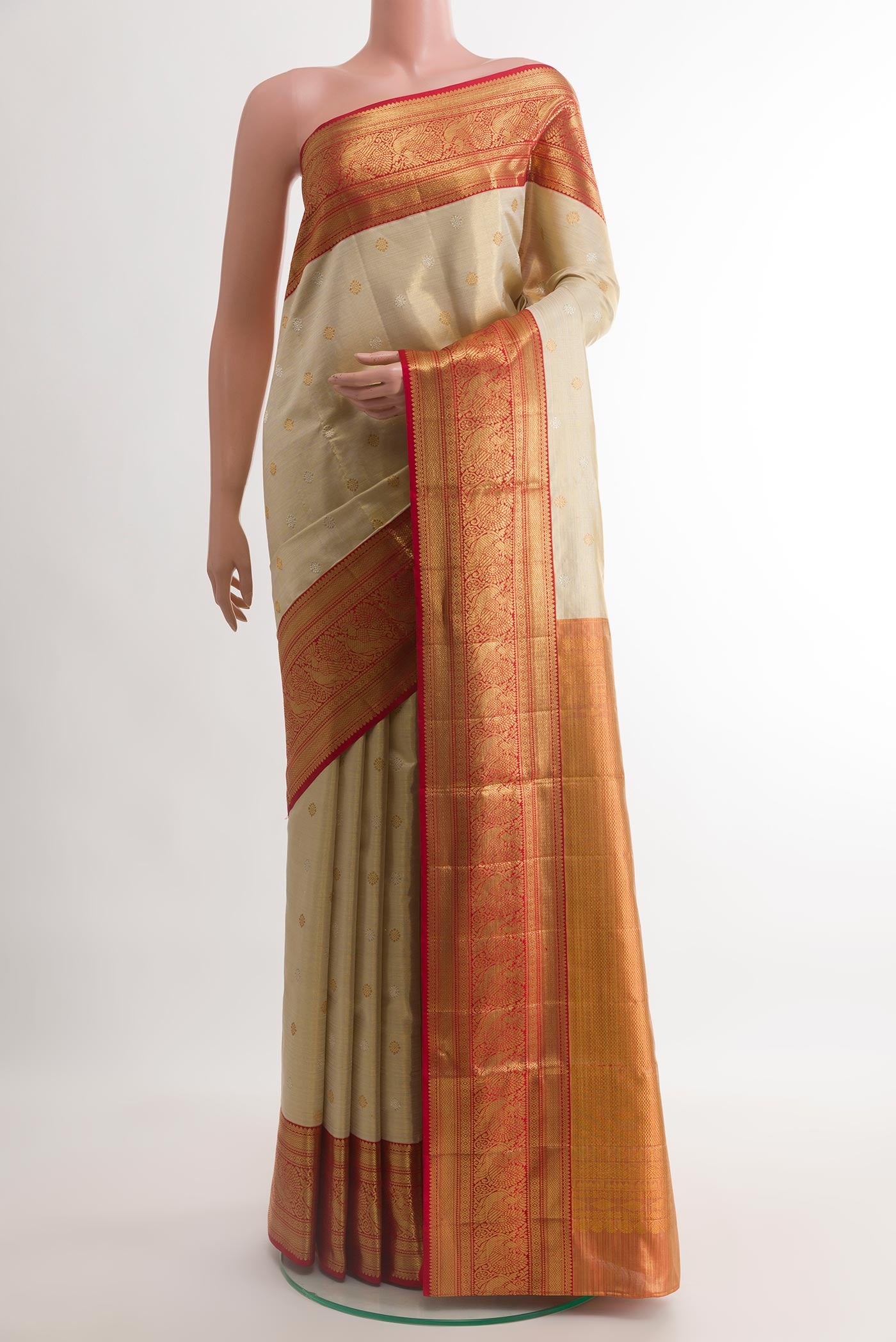 Golden Kanjivaram Tissue Silk Saree with Zari Butta on the body and Zari Border.  displayed on a mannequin