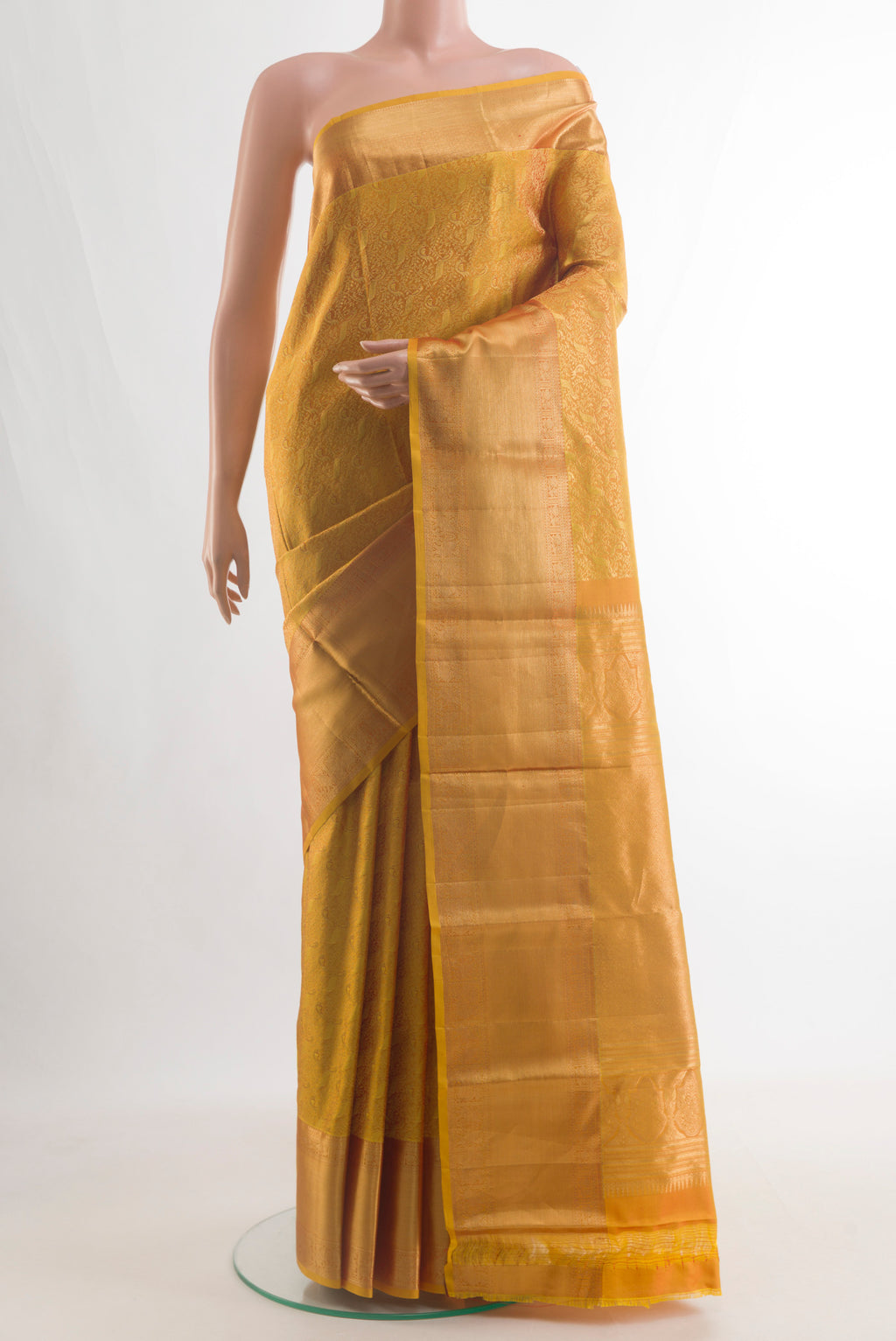 Pure Silk Mustard Kanchipuram Saree with Zari Brocade on the body and Zari Border.  displayed on a mannequin