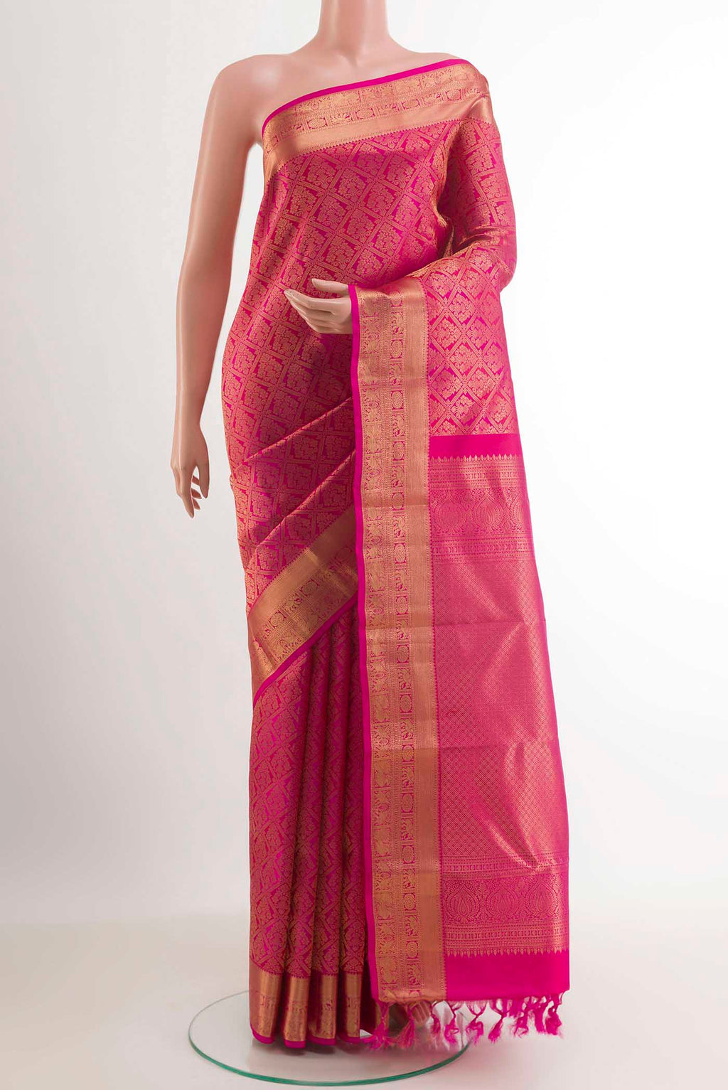 Rani Pink Kanchipuram Silk Saree with Zari Brocade on the body and Zari Border.  displayed on a mannequin