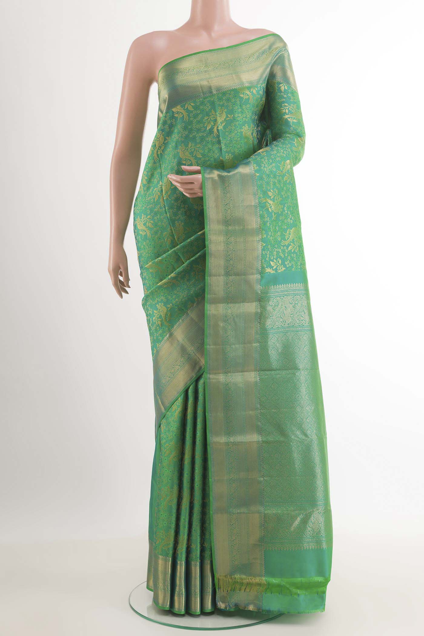 Green Dual Tone Kanchipuram Silk Saree with Zari Brocade on the body and Zari Border.  displayed on a mannequin