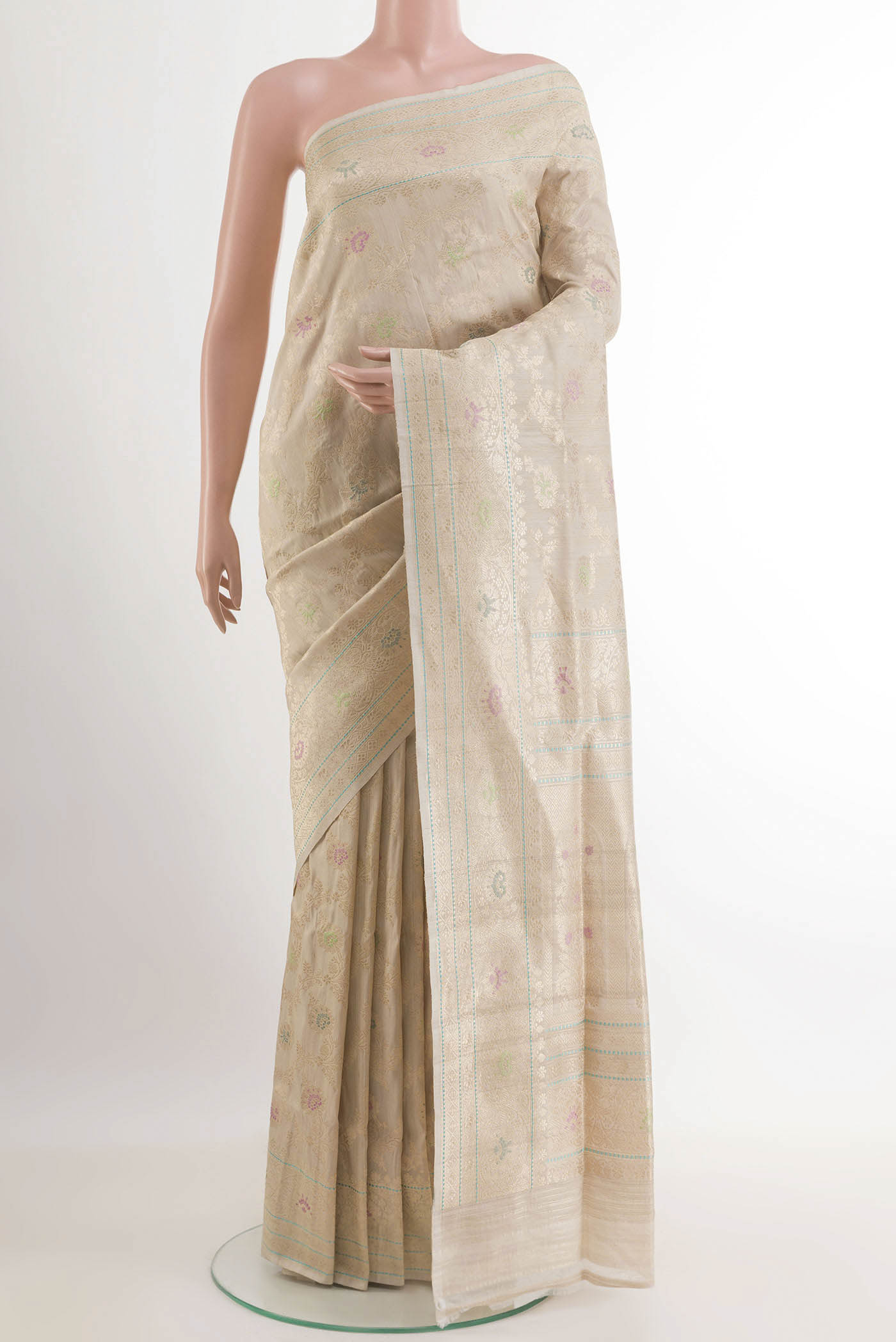 Off White Banarasi Tussar Silk Saree with Zari Butta on the body and Zari Border.  displayed on a mannequin