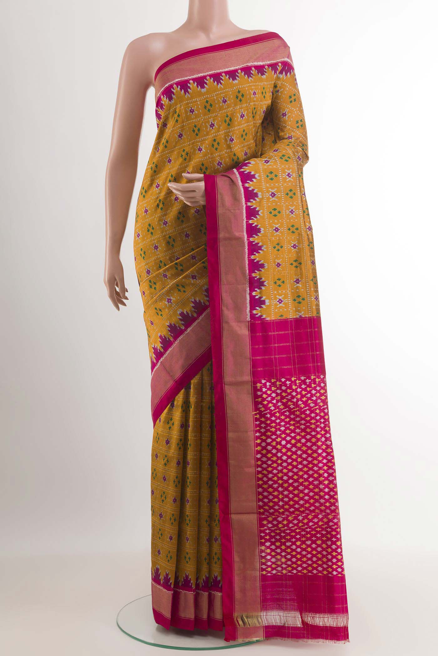 Mustard Pochampally Silk Saree with Pure Ikat on the body and Zari Border.  displayed on a mannequin