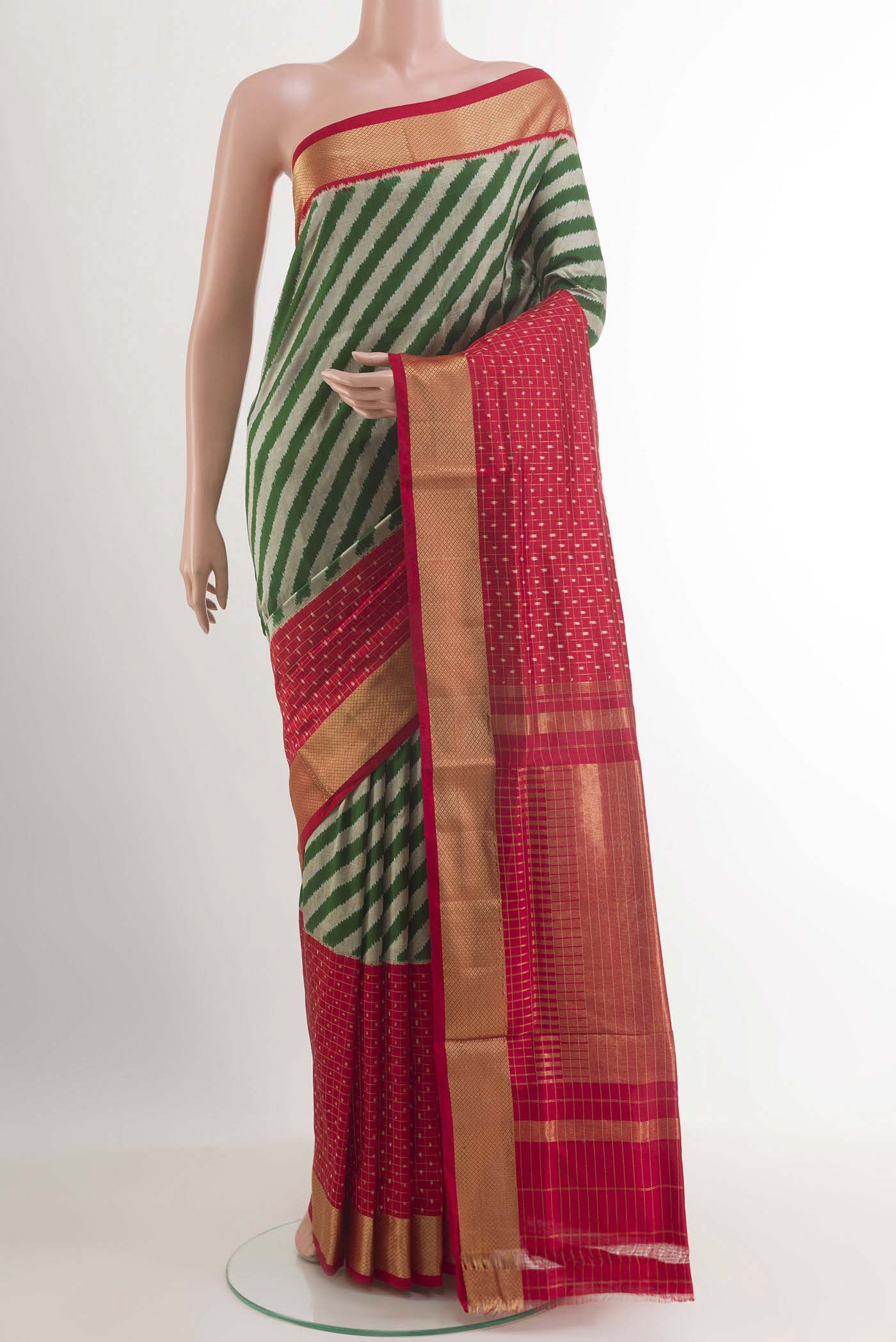 Green Pochampally Silk Saree with Pure Ikat on the body and Zari Border.  displayed on a mannequin