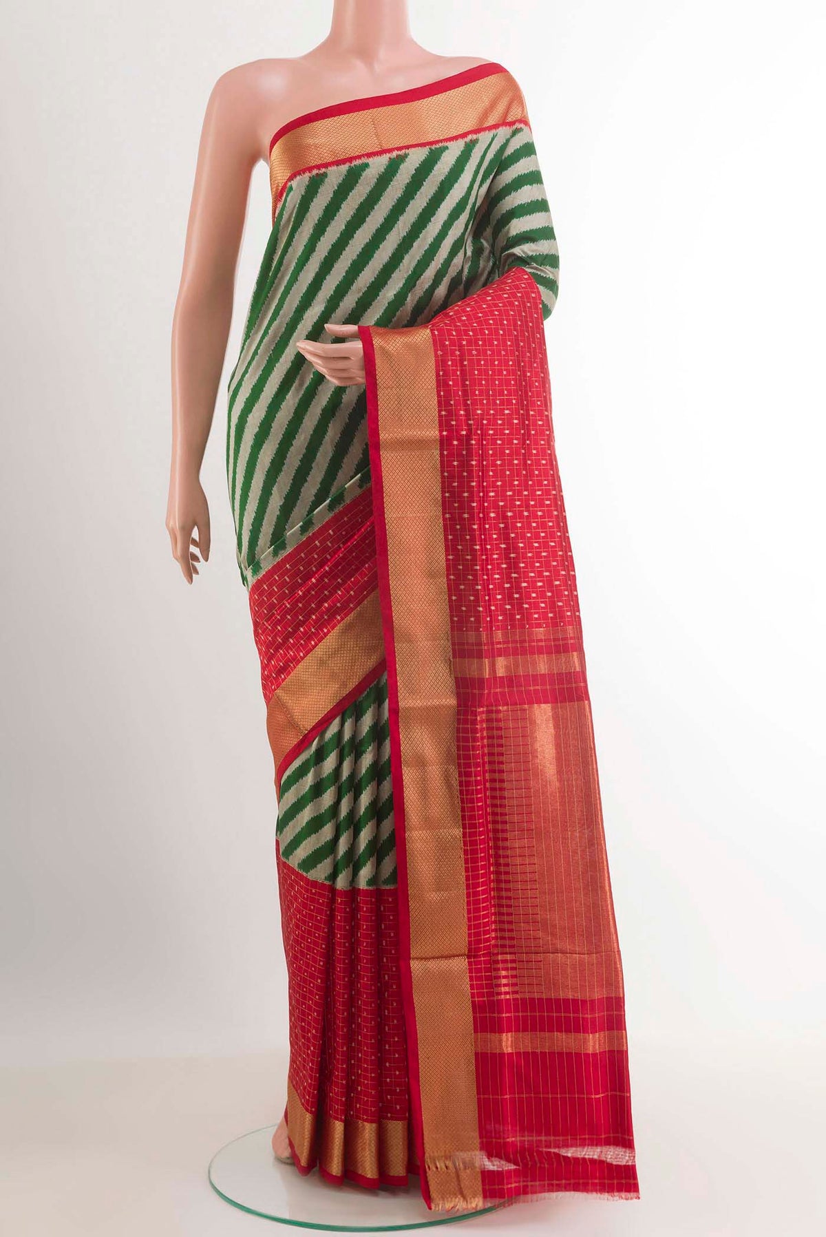 Green Pochampally Silk Saree with Pure Ikat on the body and Zari Border.  displayed on a mannequin