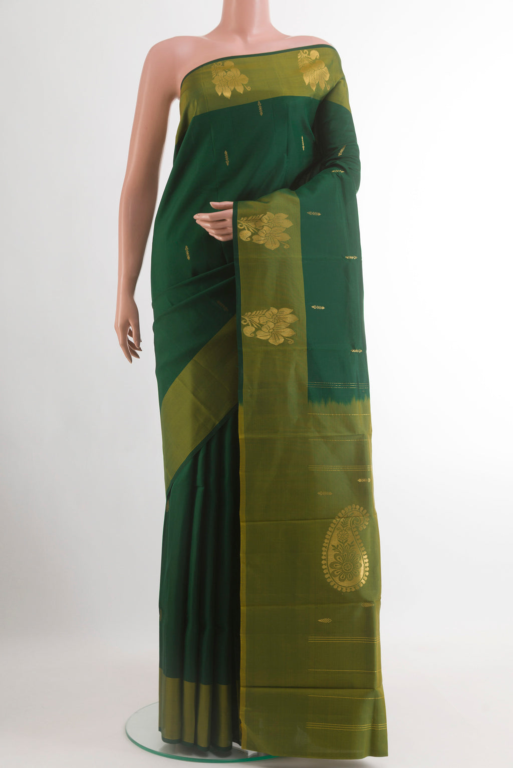 Bottle Green Kanchipuram Silk Saree with Zari Butta on the body and Zari Border.  displayed on a mannequin
